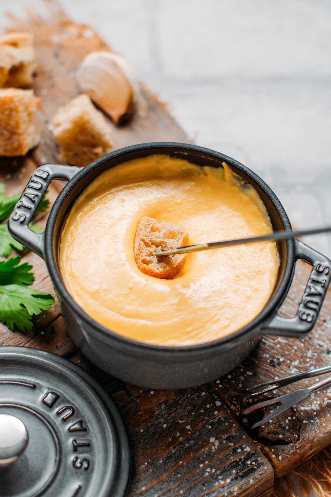 Dipping bread into vegan fondue.