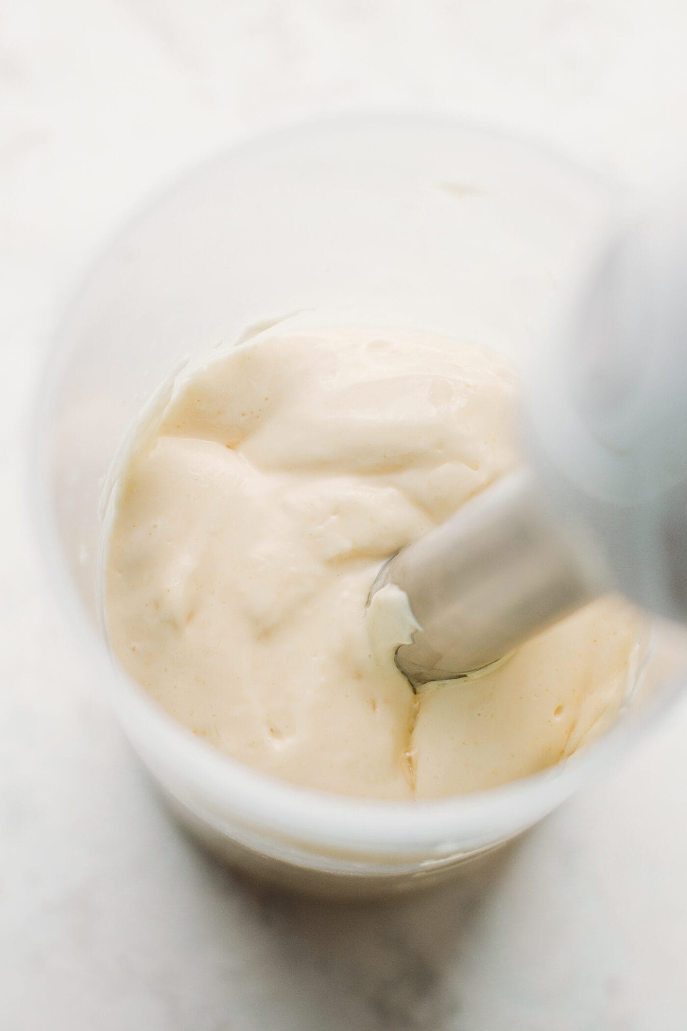 Vegan mayonnaise in an immersion blender cup.