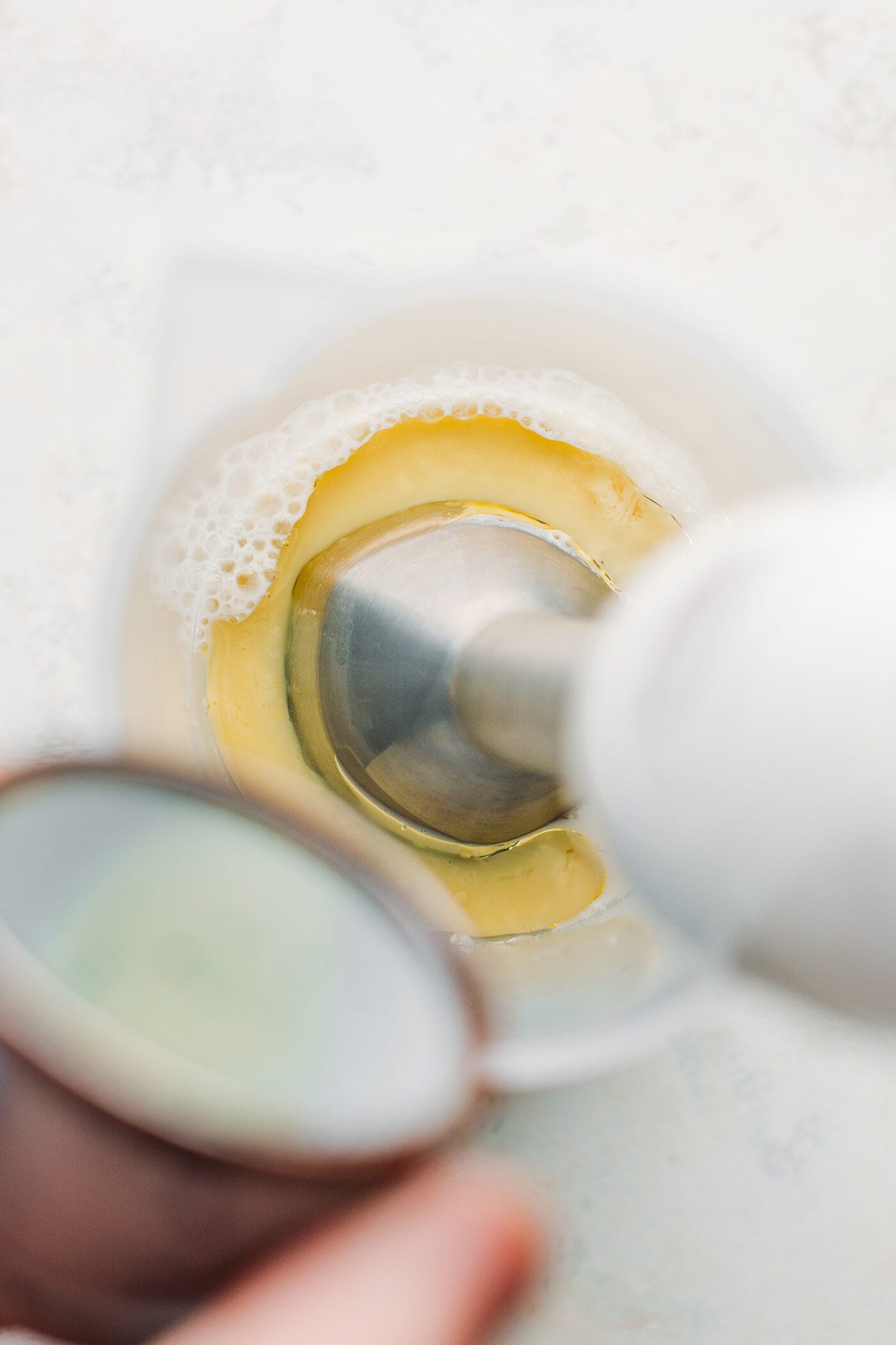 Making mayonnaise with an immersion blender.