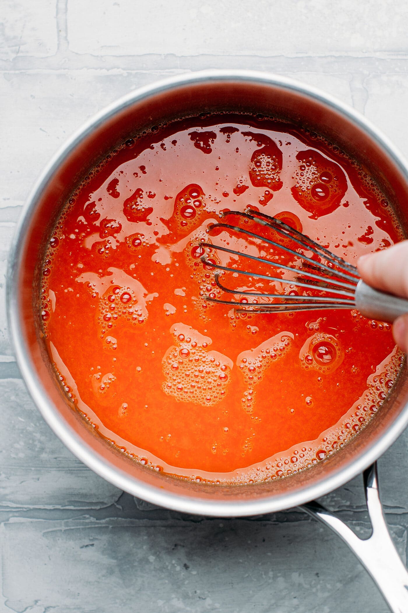 Whisking a batter to make vegan salmon sashimi.