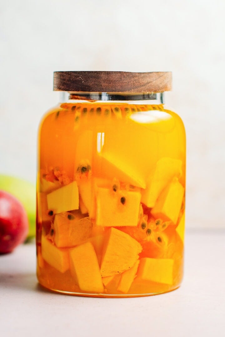 Mango and passion fruit liquor in a glass jar.