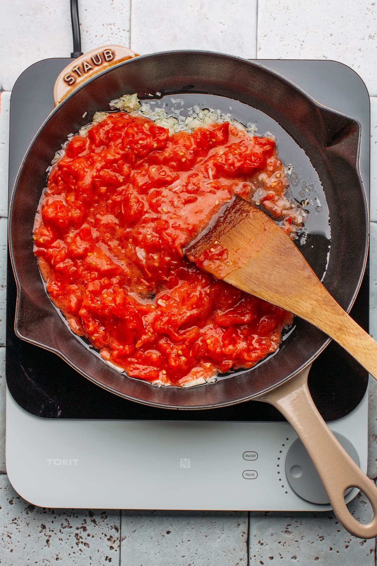 Crushed tomatoes and garlic in a skillet.