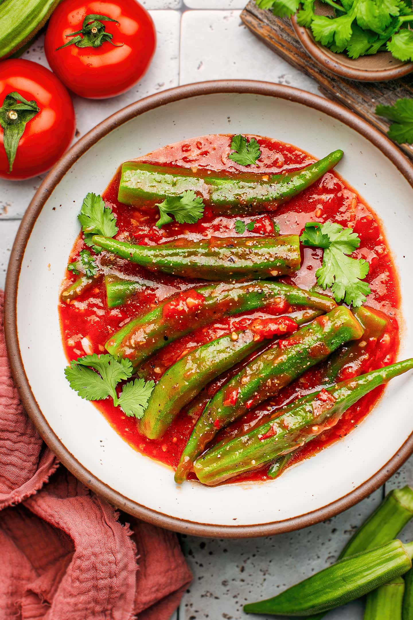 Okra pods in sweet tomato sauce in a bowl.