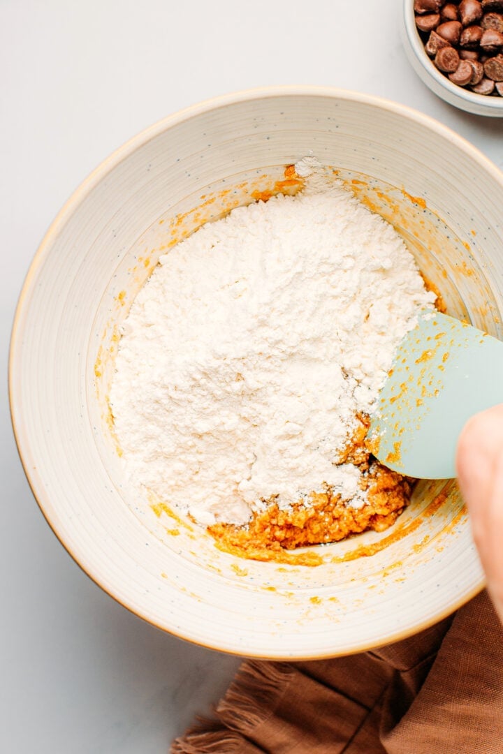 Mixing flour with butter and sugar.