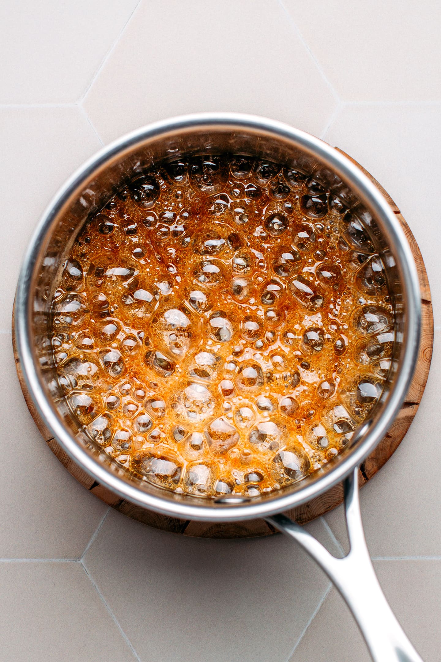 Maple syrup boiling in a saucepan.