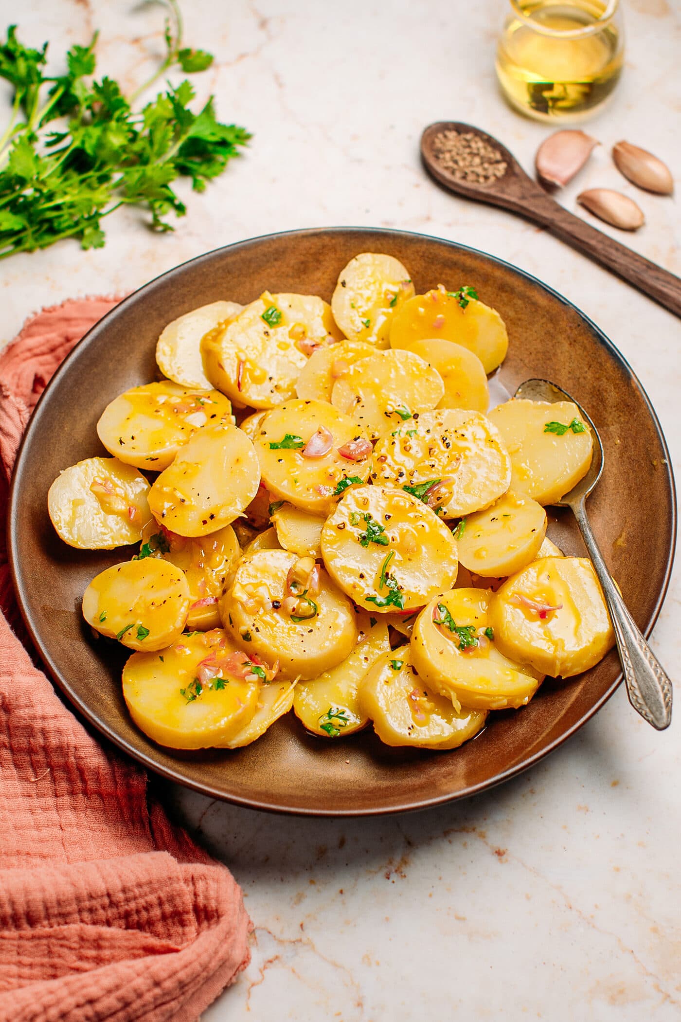 Vegan potato salad on a plate with vinaigrette.