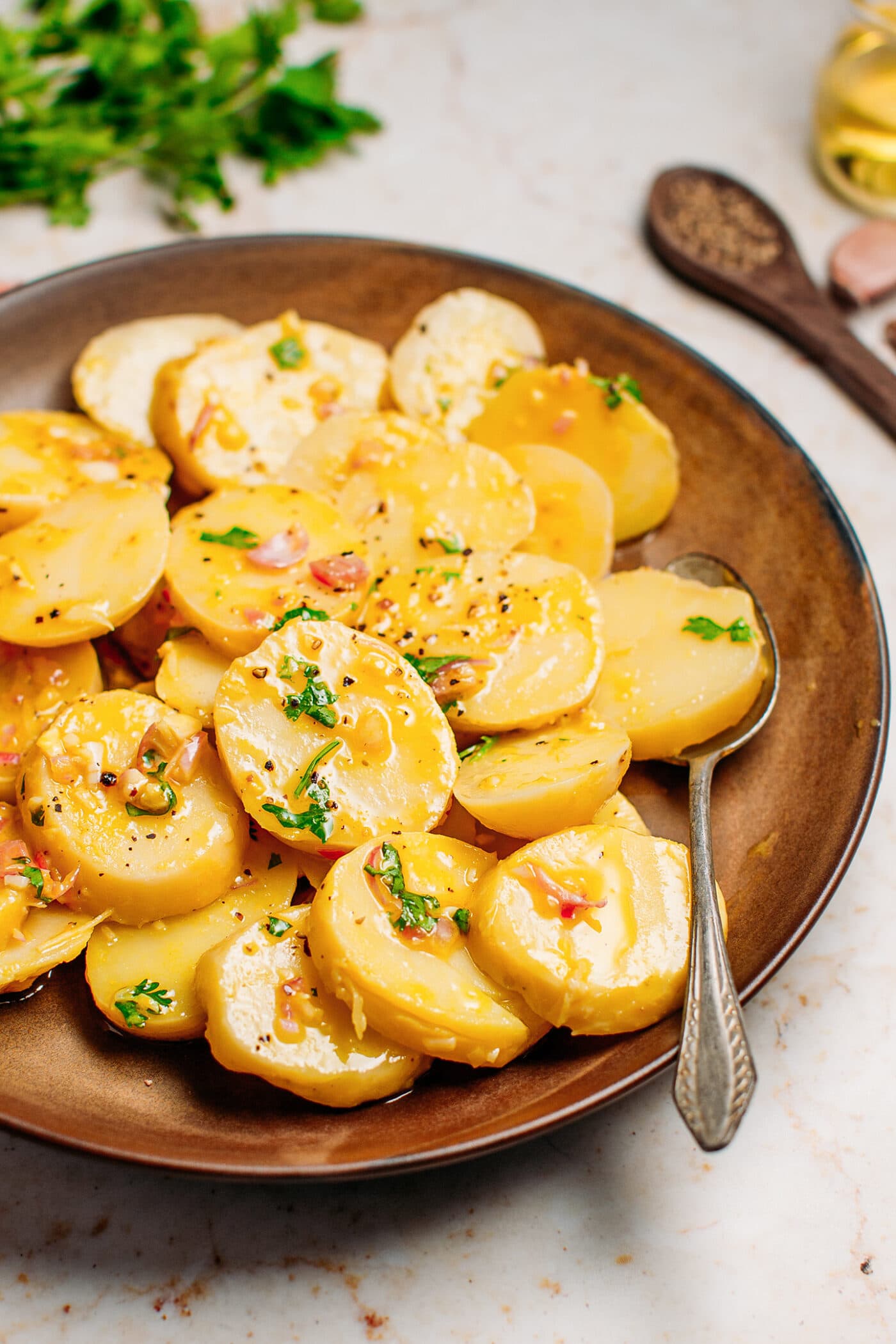 Close up of vegan potato salad with cilantro and black pepper.