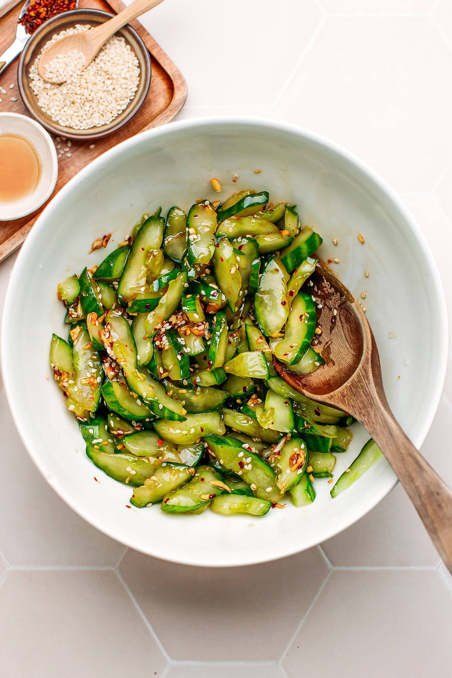 Cucumbers seasoned with soy sauce, sesame oil, and vinegar in a bowl.