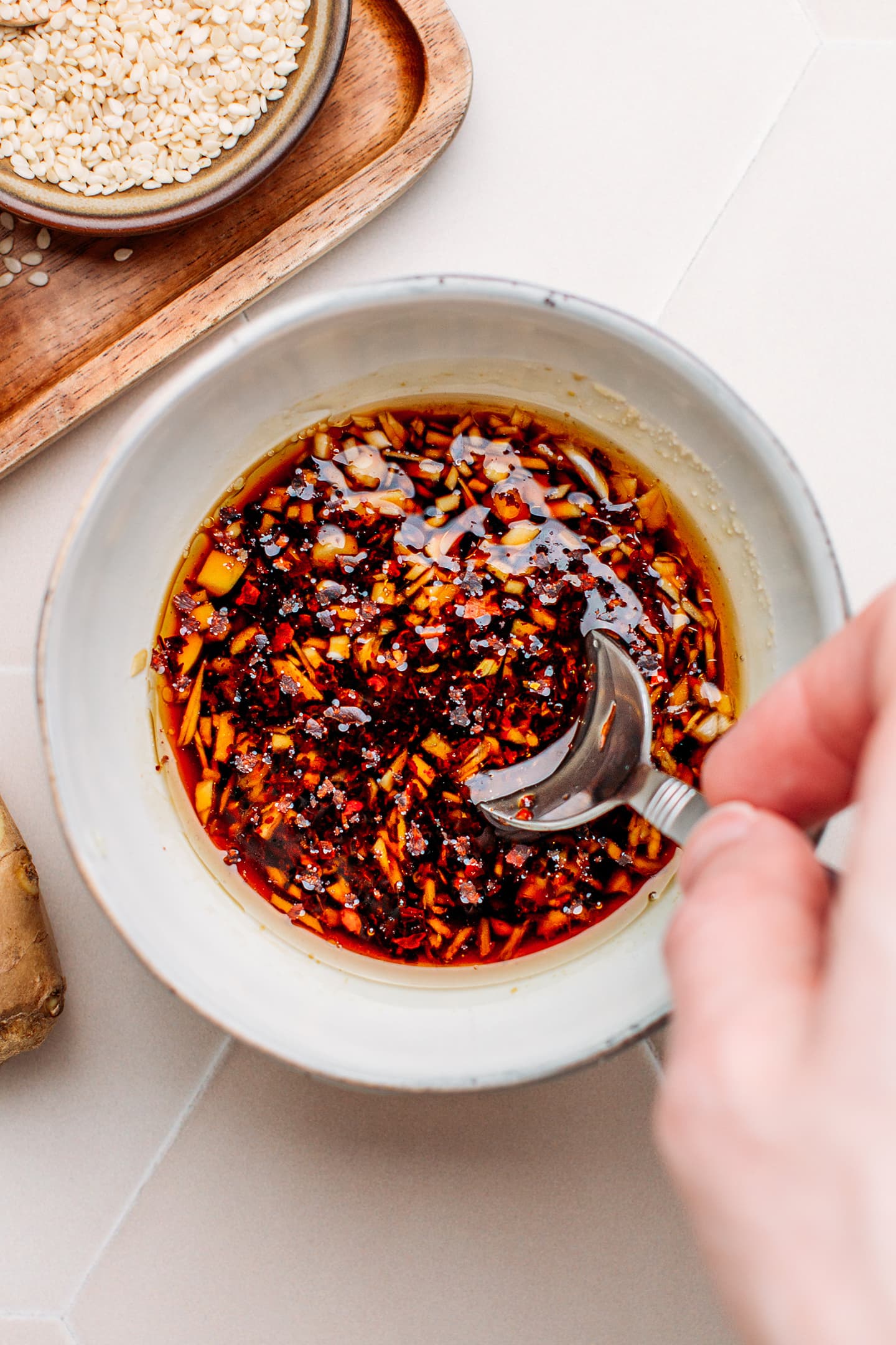 Stirring a dressing in a small bowl.