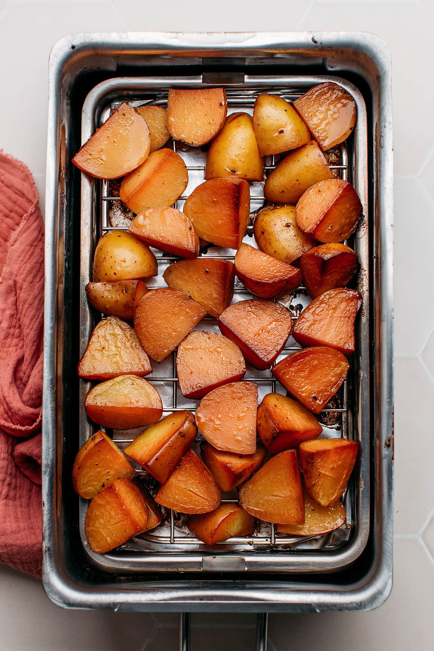 Quartered smoked potatoes in a stovetop smoker.