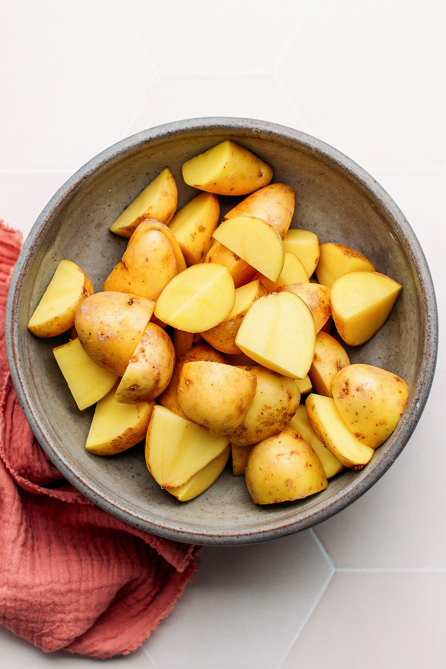 Quartered potatoes in a bowl.