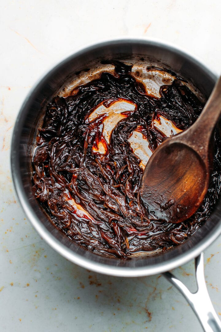 Caramelized shallots in a saucepan.