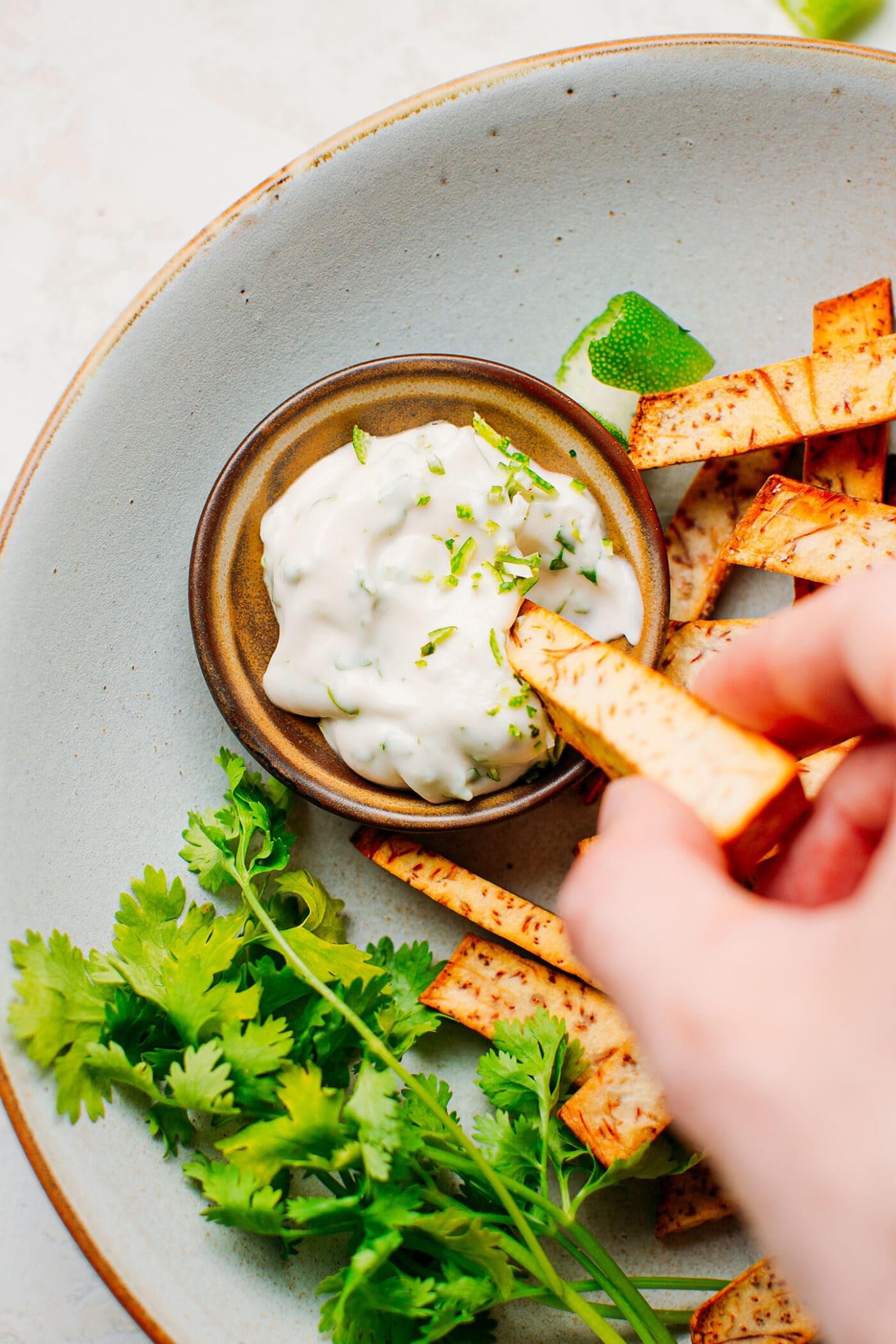 Dipping taro fries in cilantro mayo.