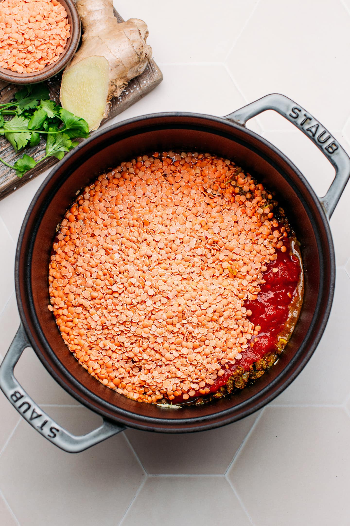 Red lentils and crushed tomatoes in a pot.