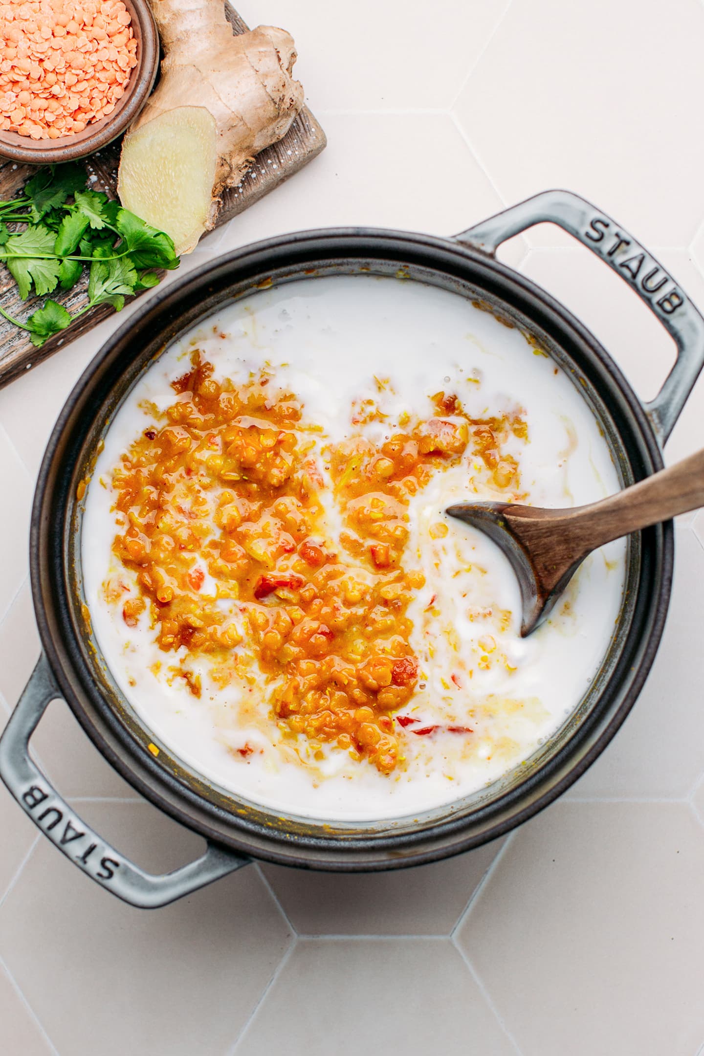 Cooked red lentils with coconut milk in a pot.