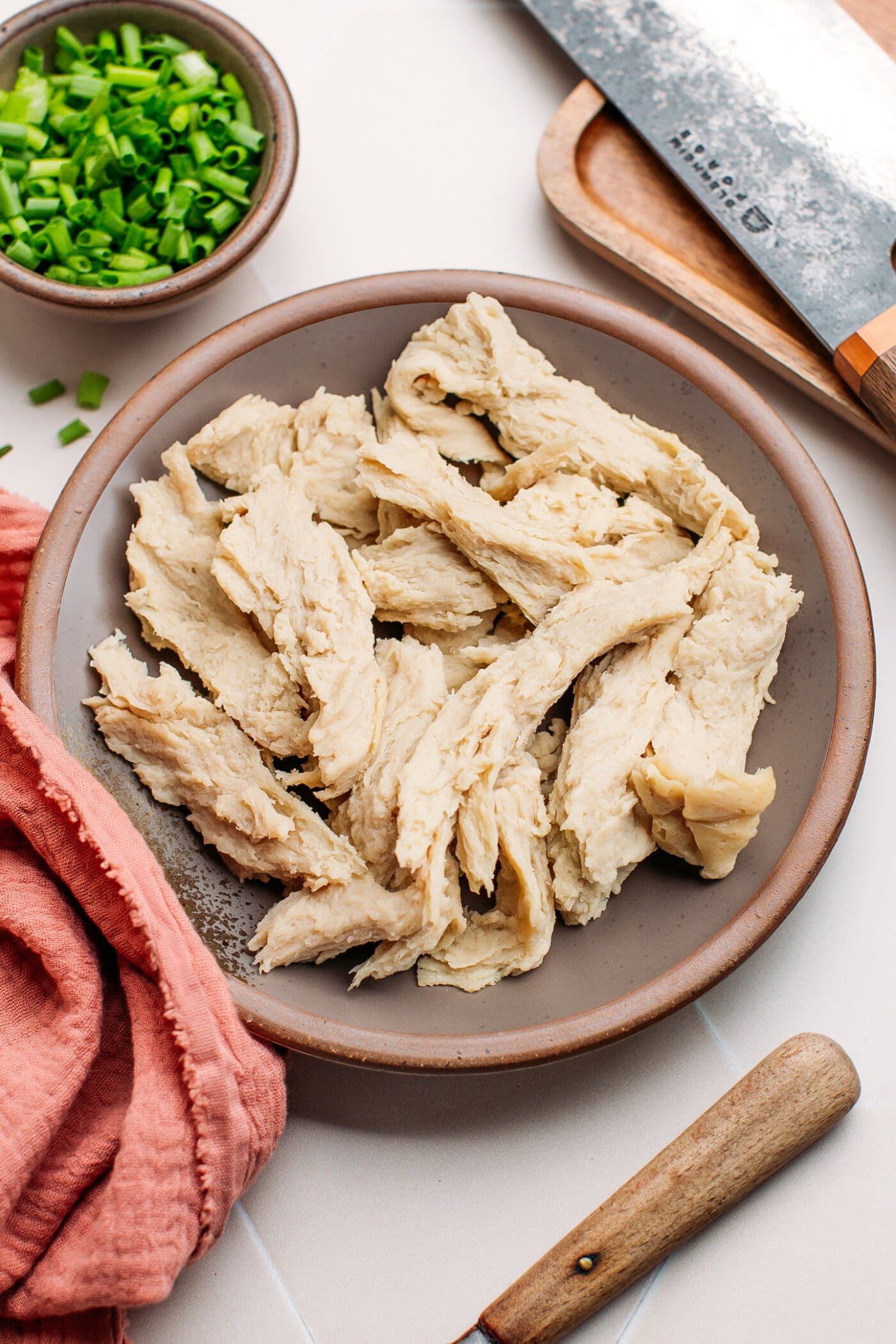 Best vegan chicken breasts made with gluten, on a wood plate.