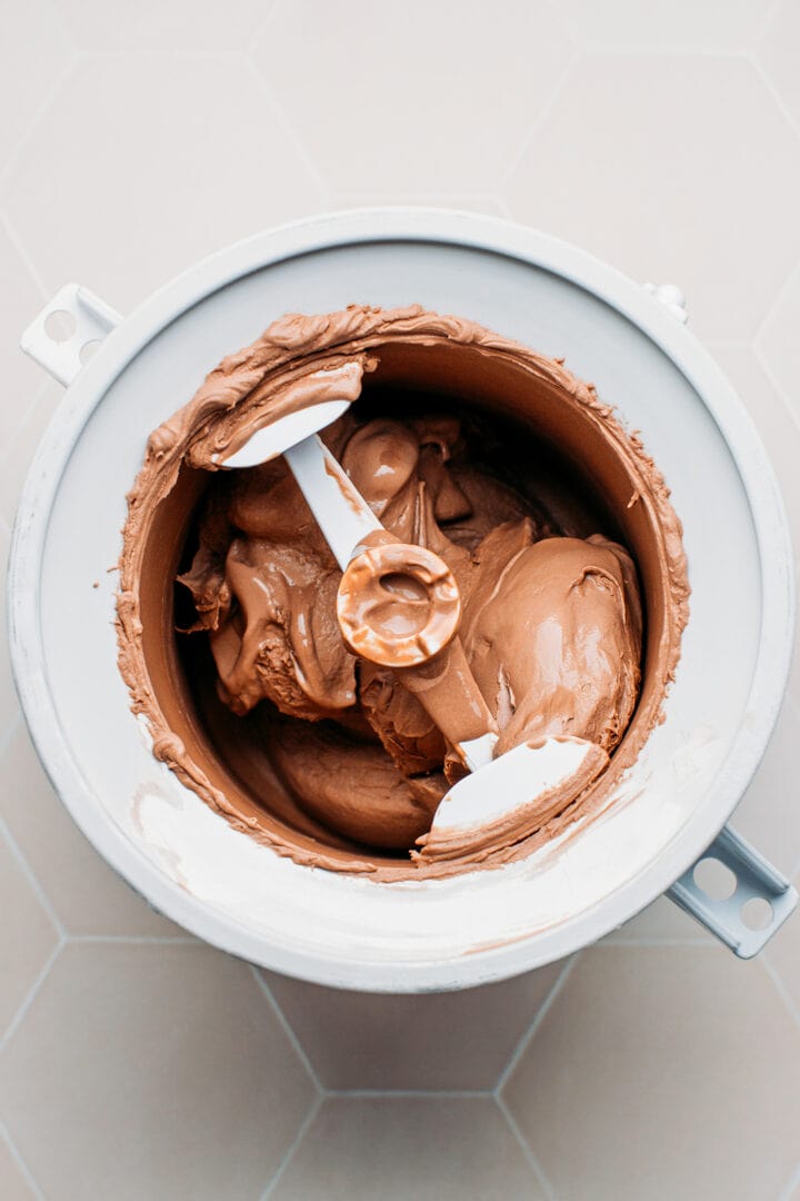 Churning chocolate ice cream in an ice cream maker.