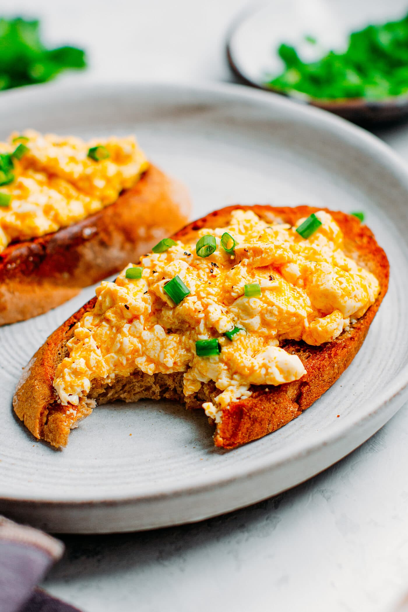 Tofu scramble on toast with green onions.