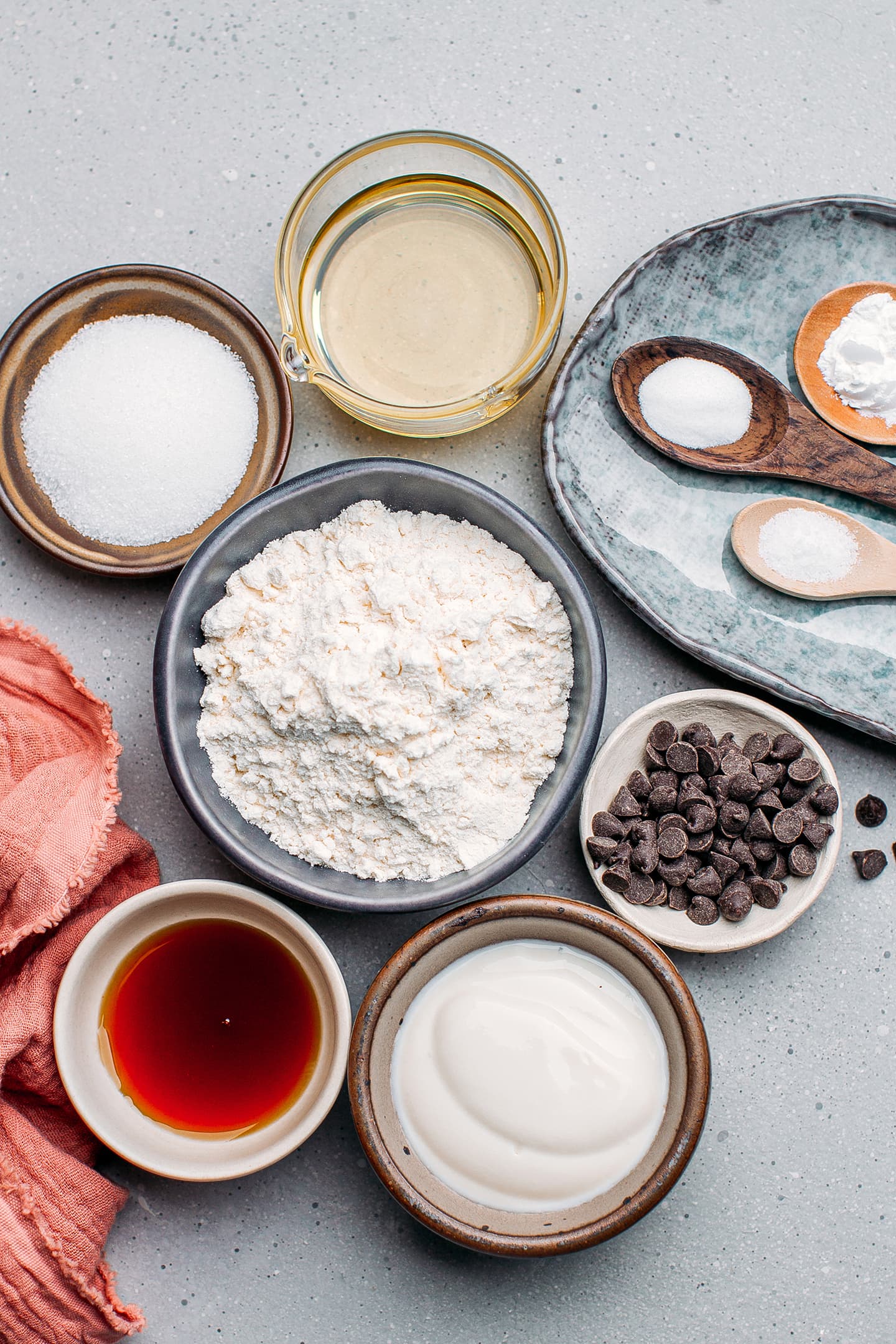 Ingredients like flour, sugar, yogurt, baking powder, vanilla extract, and chocolate chips.