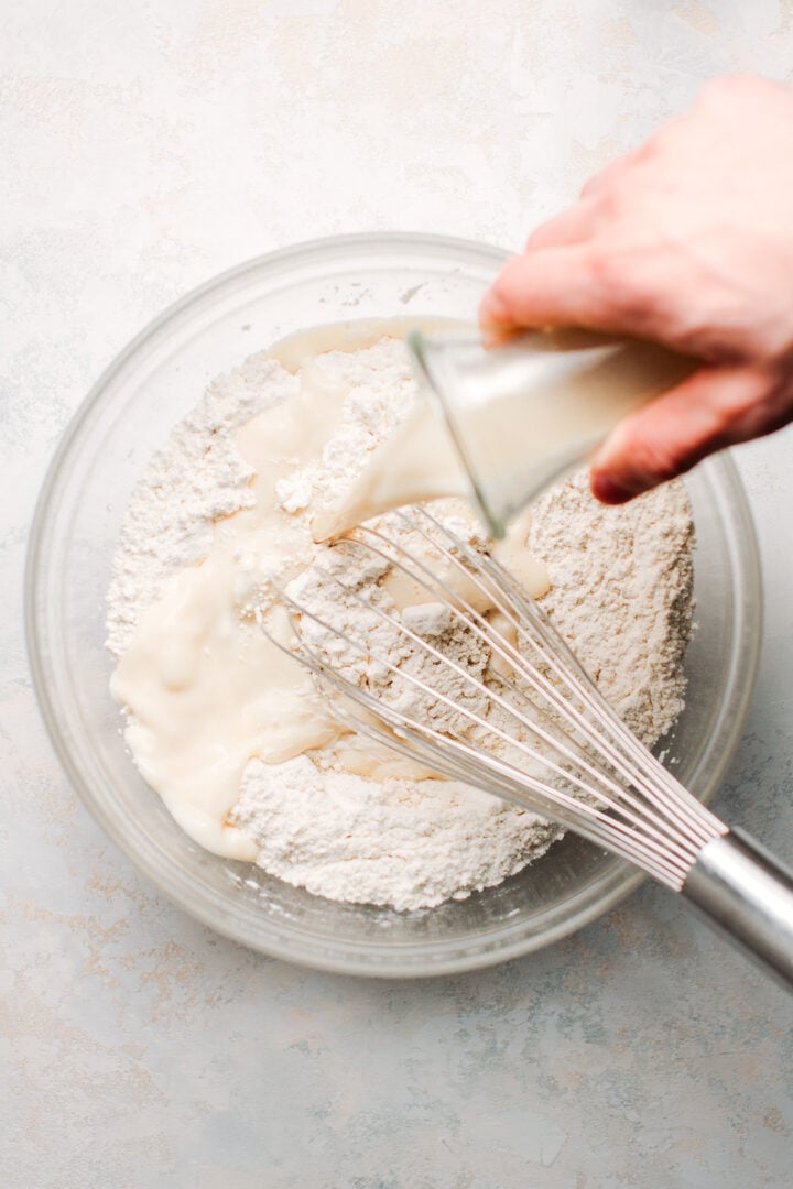 Pouring milk over flour mixture.