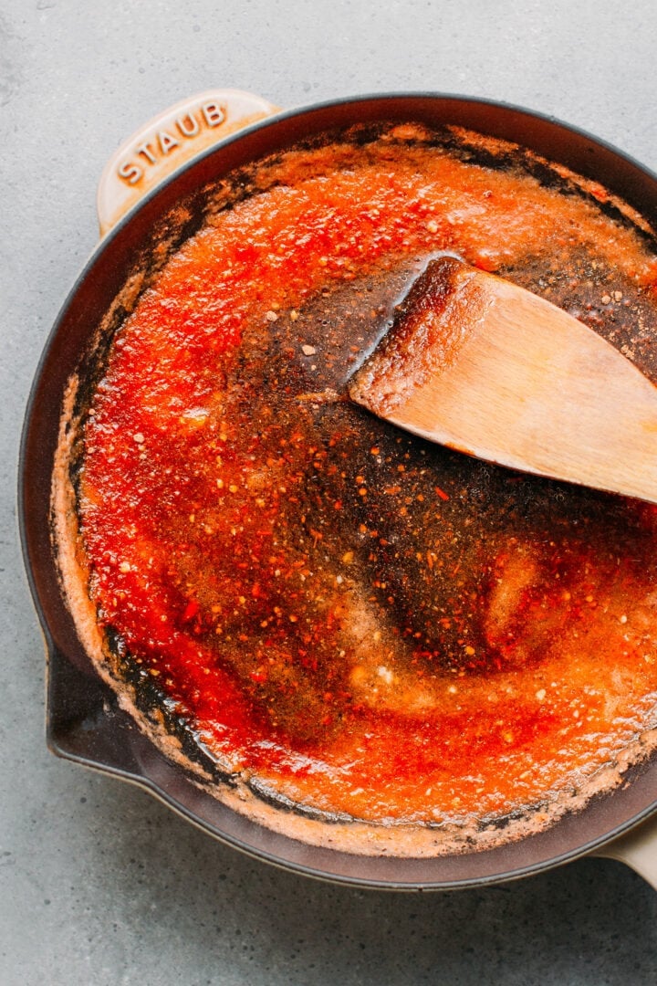 Cooking sweet and sour sauce in a skillet.