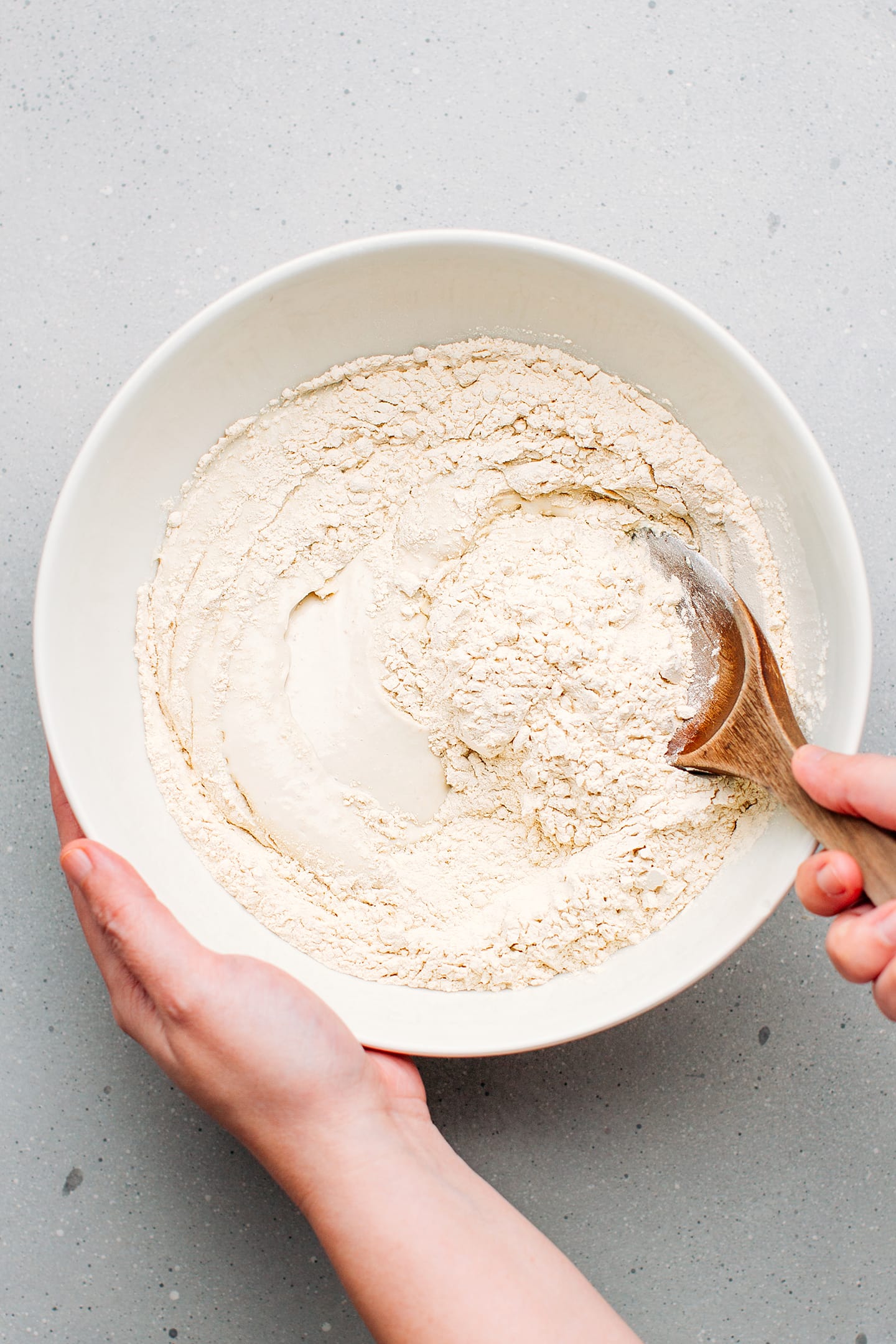 Stirring tofu with vital wheat gluten in a bowl.