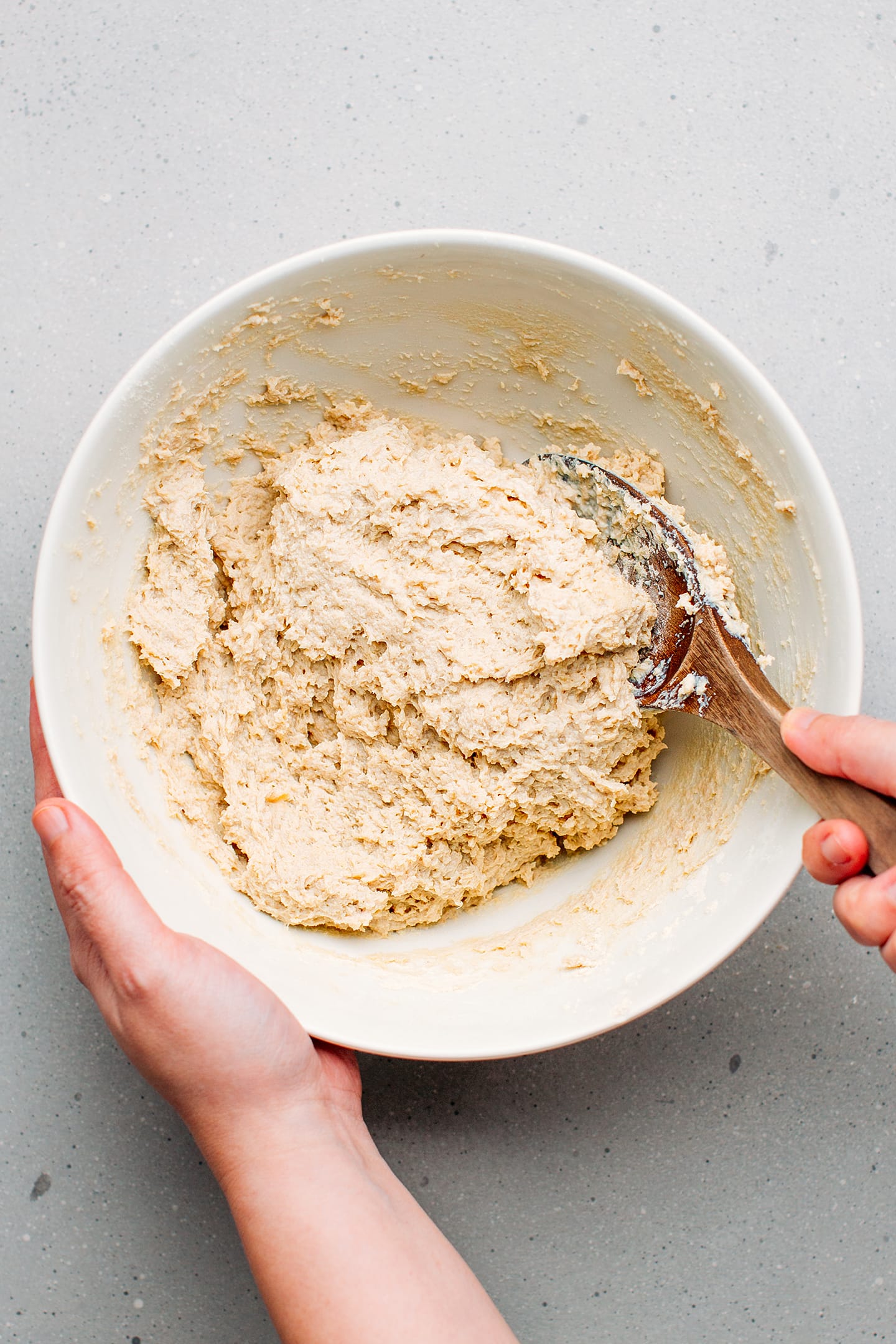 Kneading vegan bologna dough in a bowl.