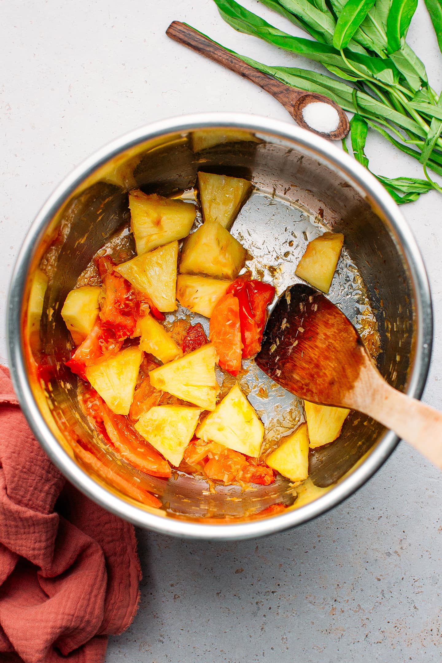 Stir-fried tomatoes and pineapple in a pot.