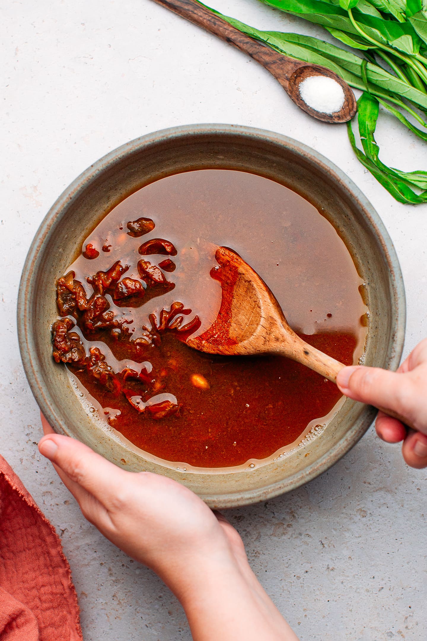 Stirring tamarind with hot water.