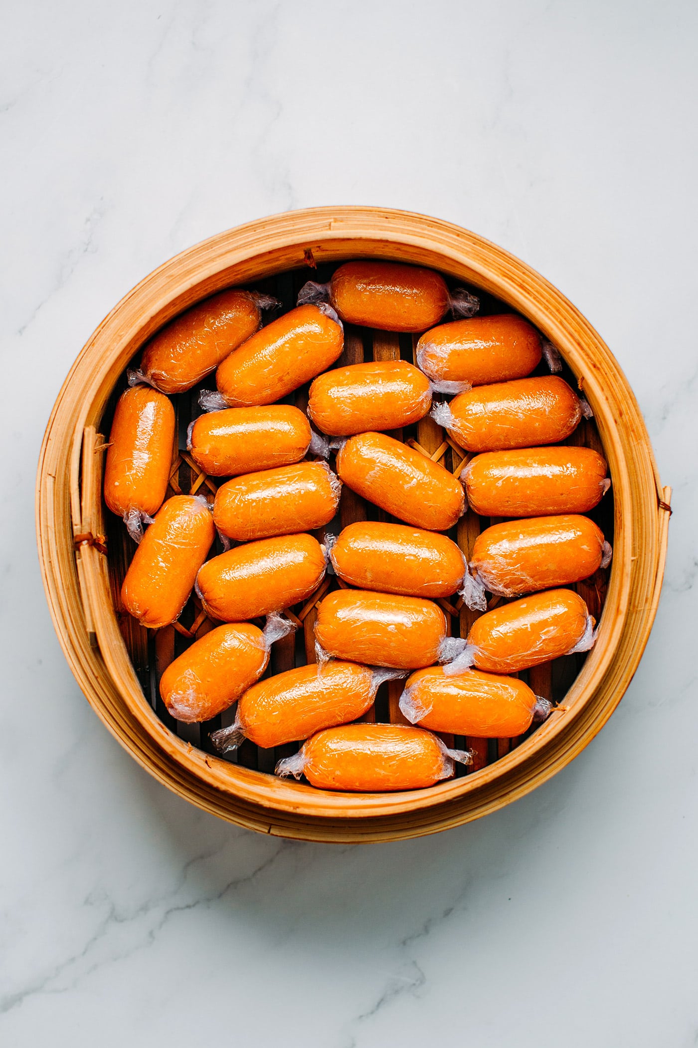 Vegan Sausages in a bamboo basket steamer