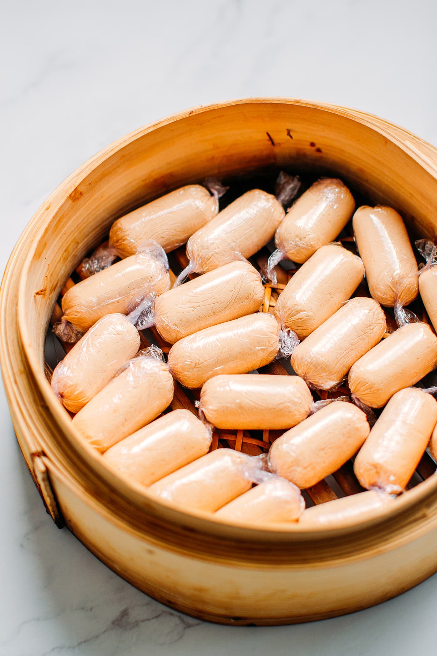 Vegan Sausages in a bamboo basket steamer