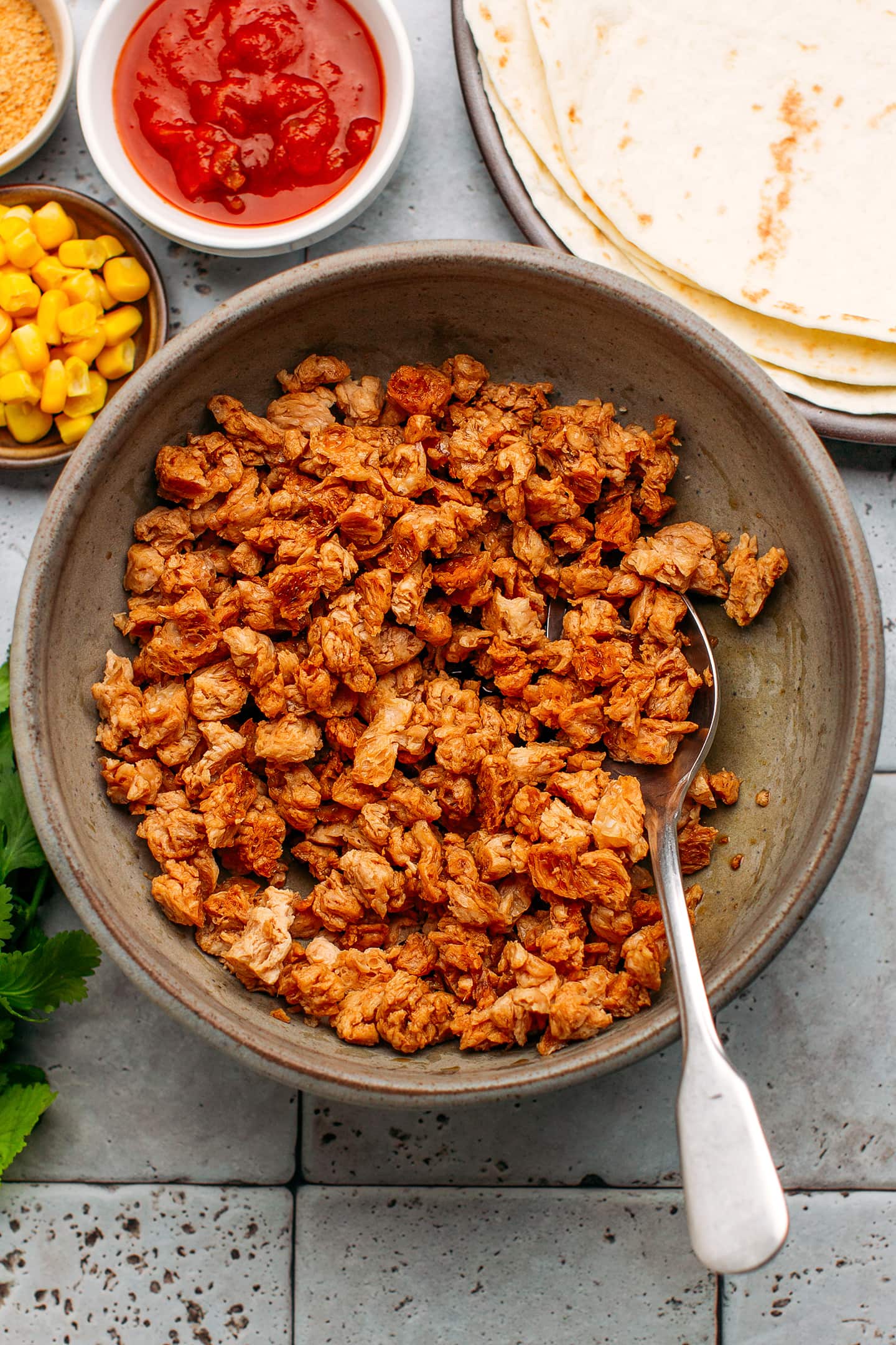 Soy curls tossed with soy sauce in a bowl.