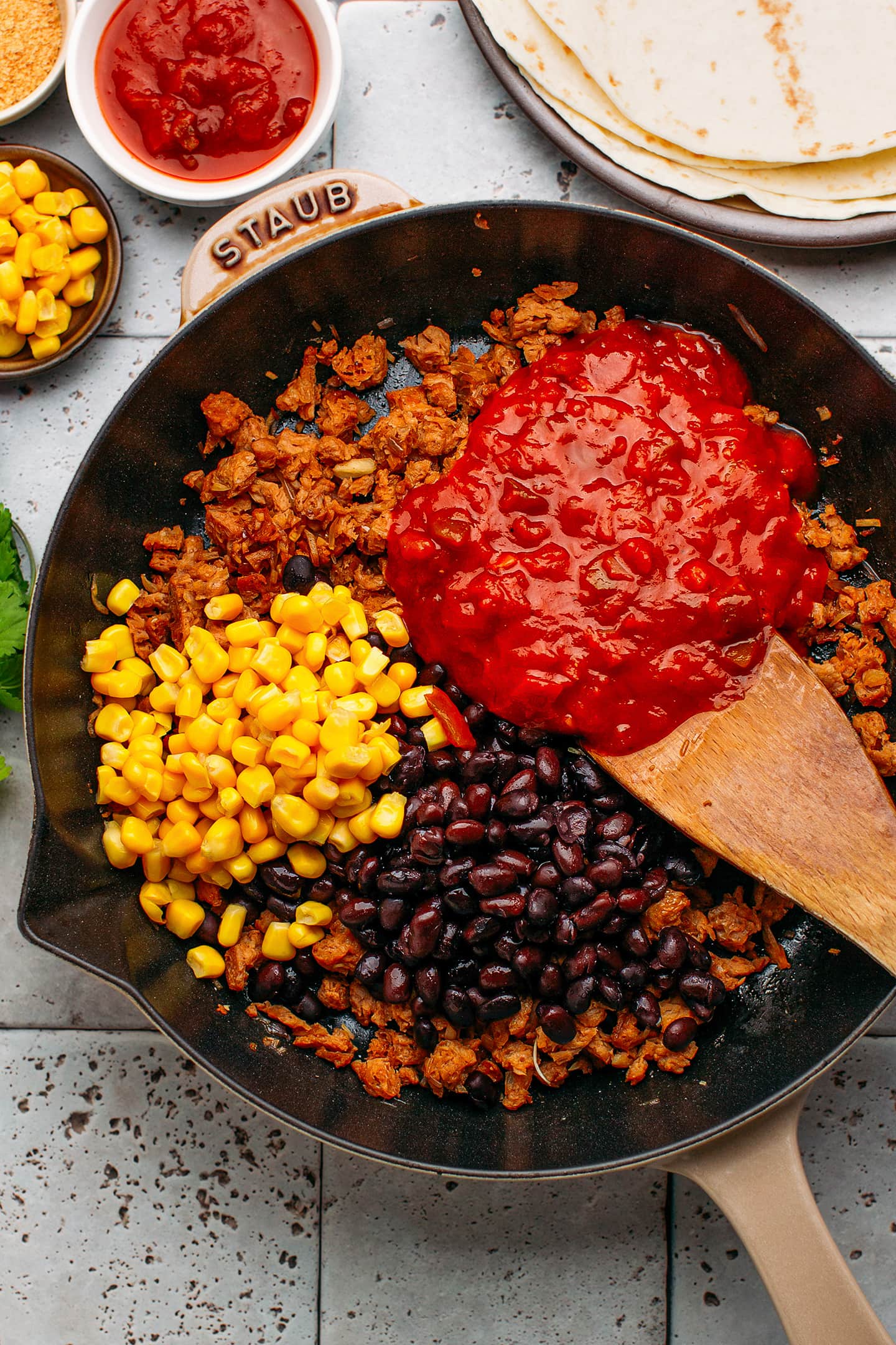 Black beans, corn, soy curls, and enchilada sauce in a skillet.