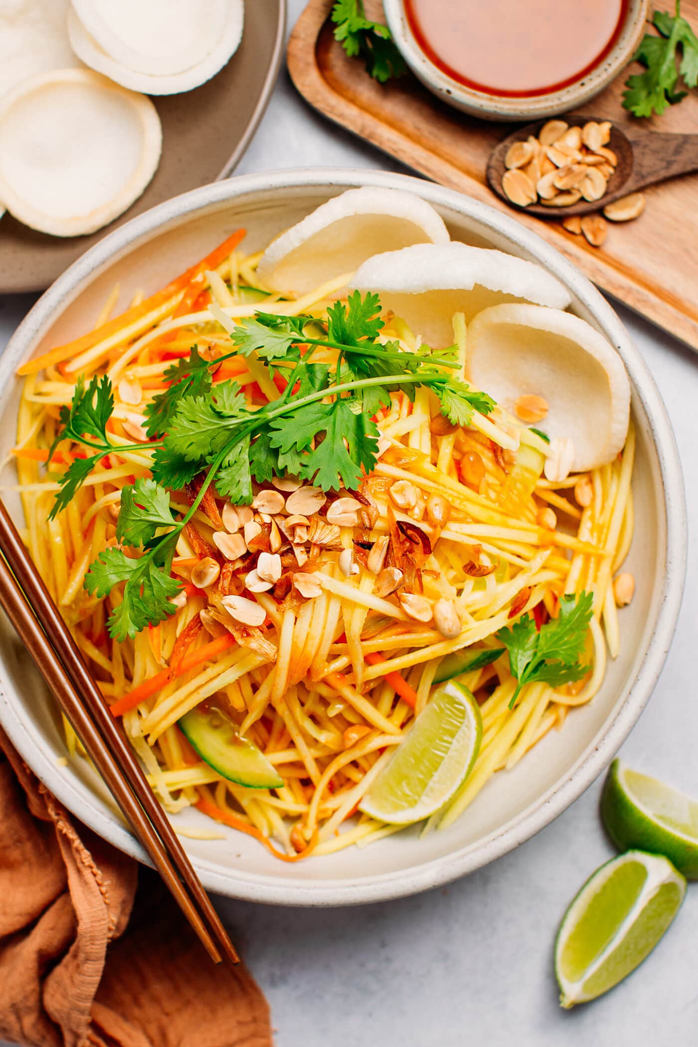 Thai mango salad with cilantro, cucumber, carrot, and peanuts.