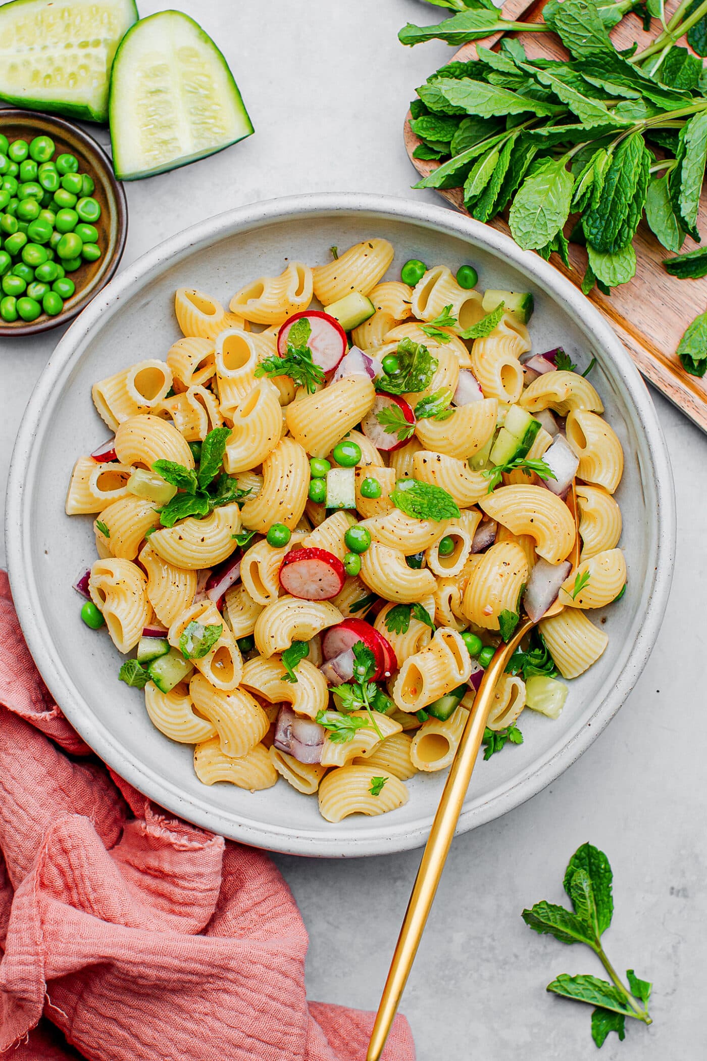 Macaroni salad with green peas, radishes, mint, and cucumber.