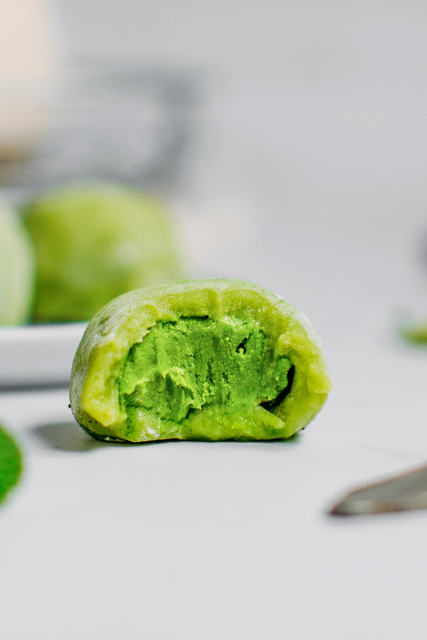 Matcha mochi close-up with a bite.