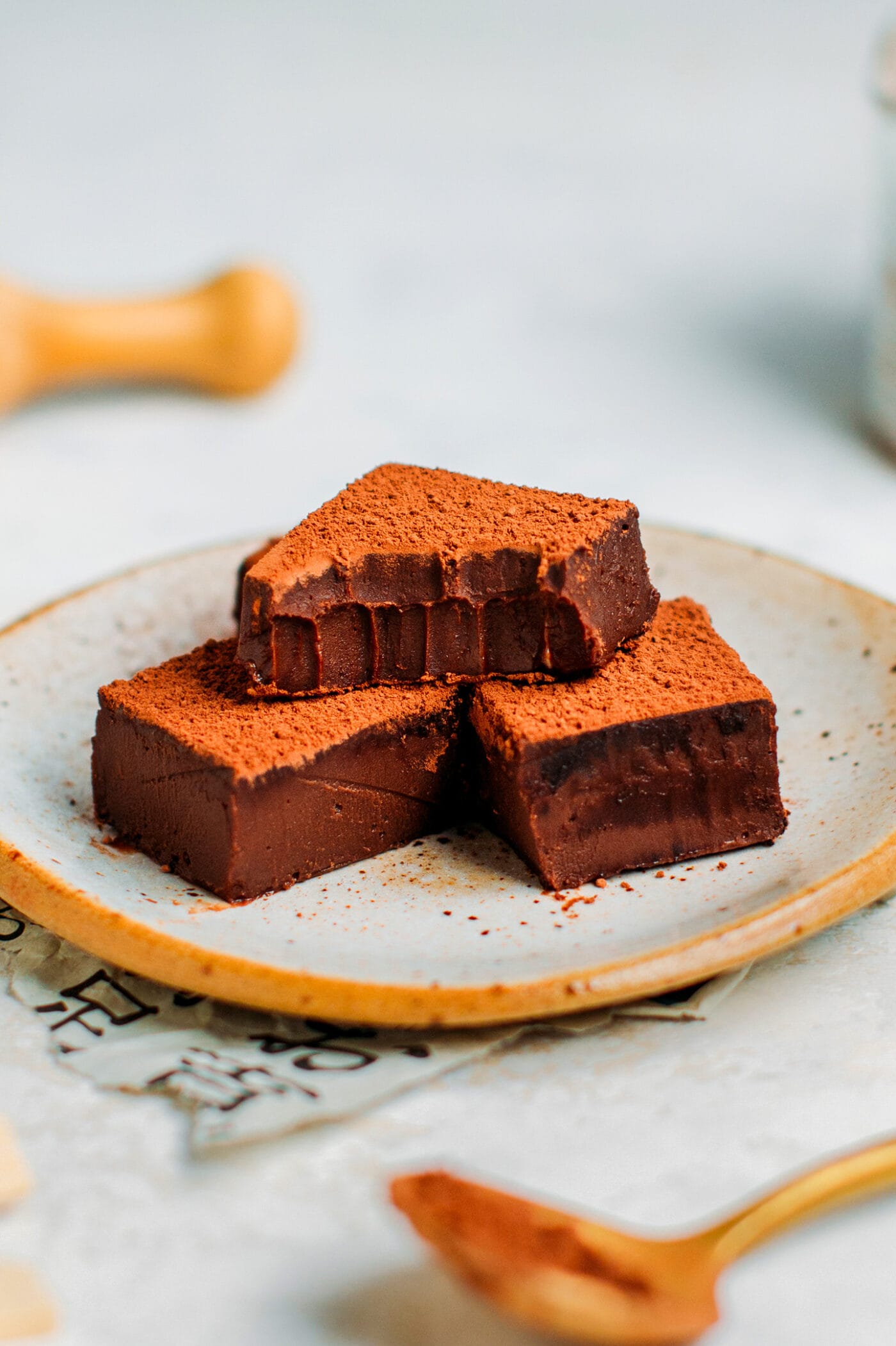 Nama chocolate squares on a plate.