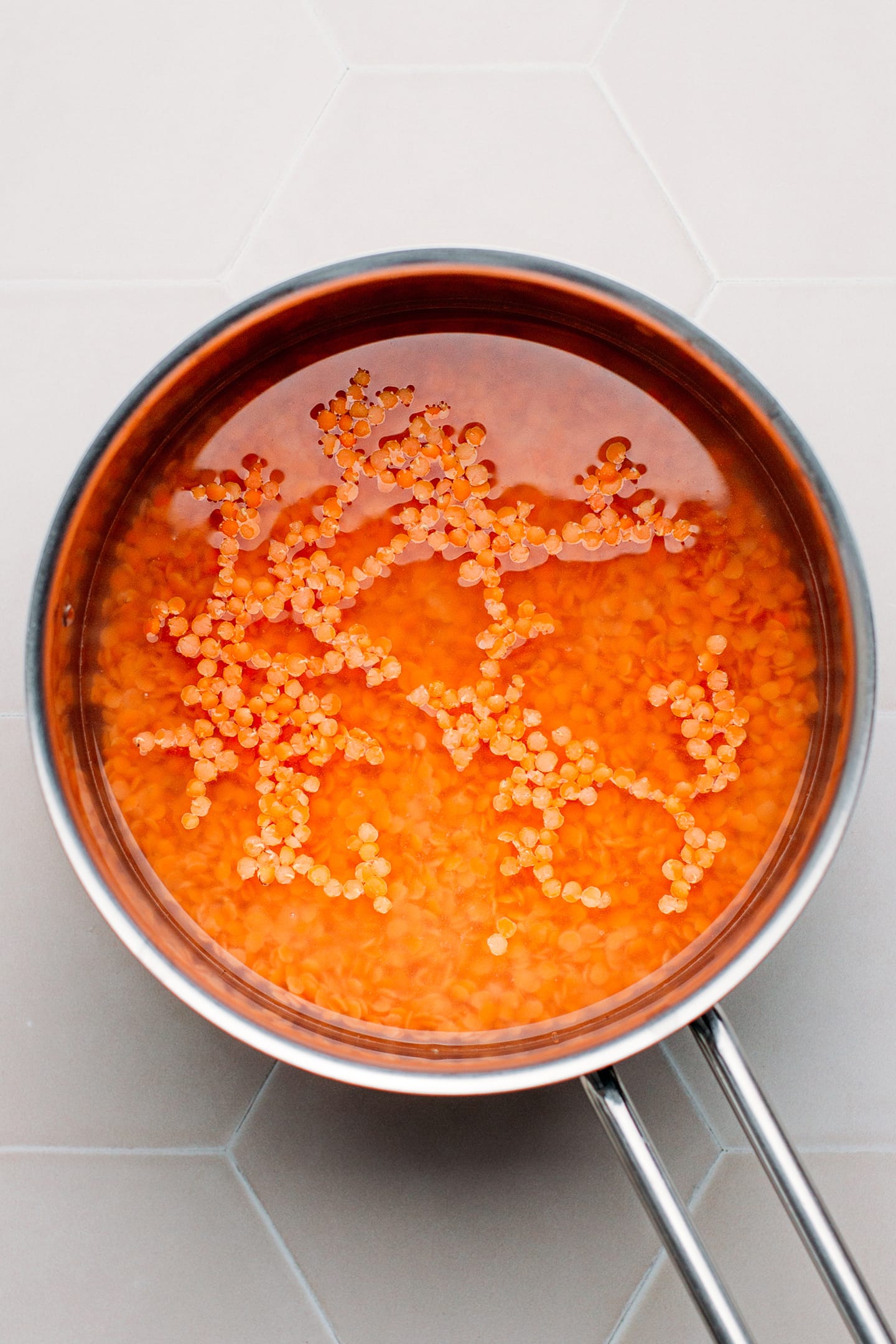 Red lentils in a saucepan.