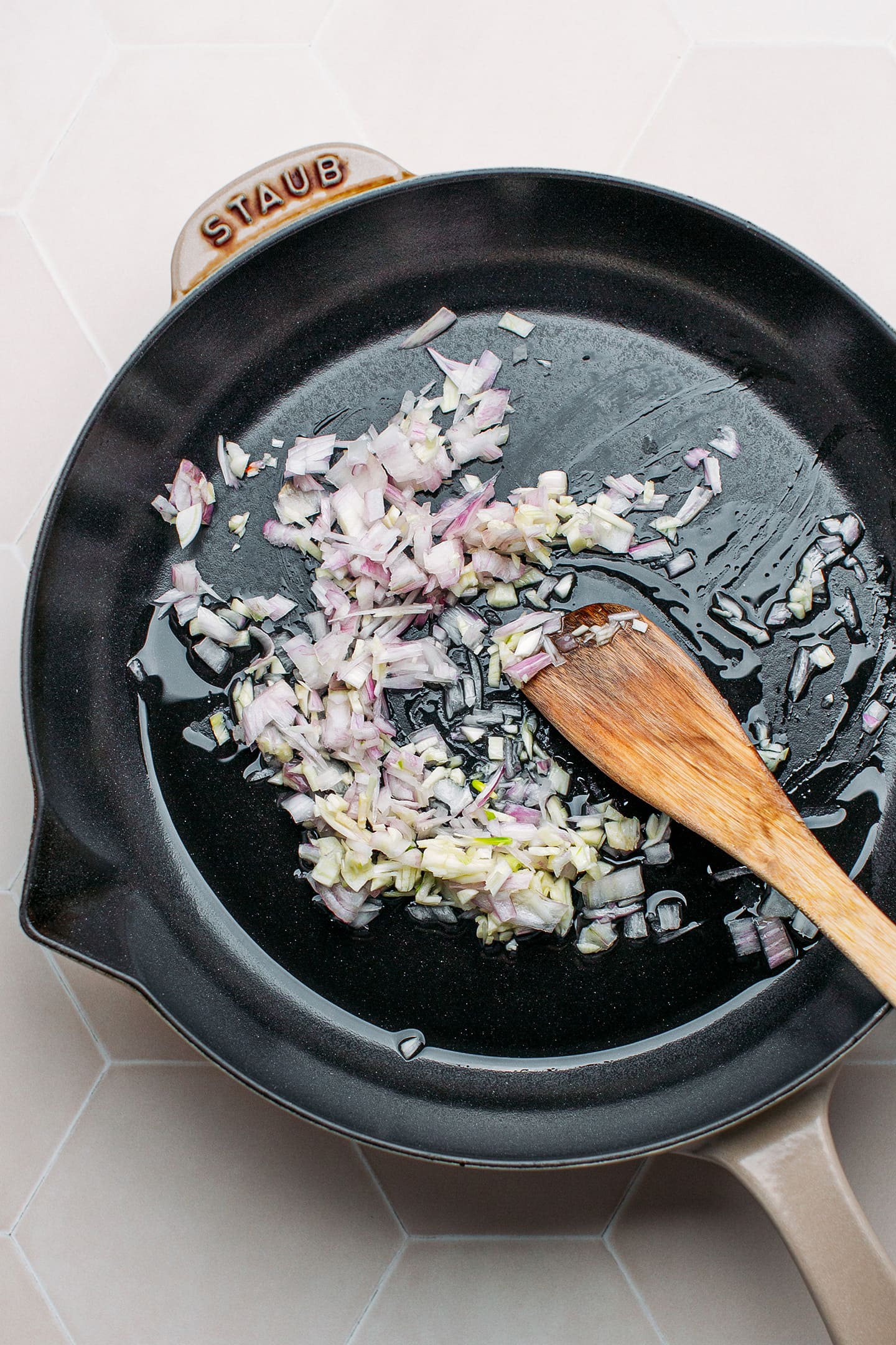 Sautéed shallots and garlic in a skillet.