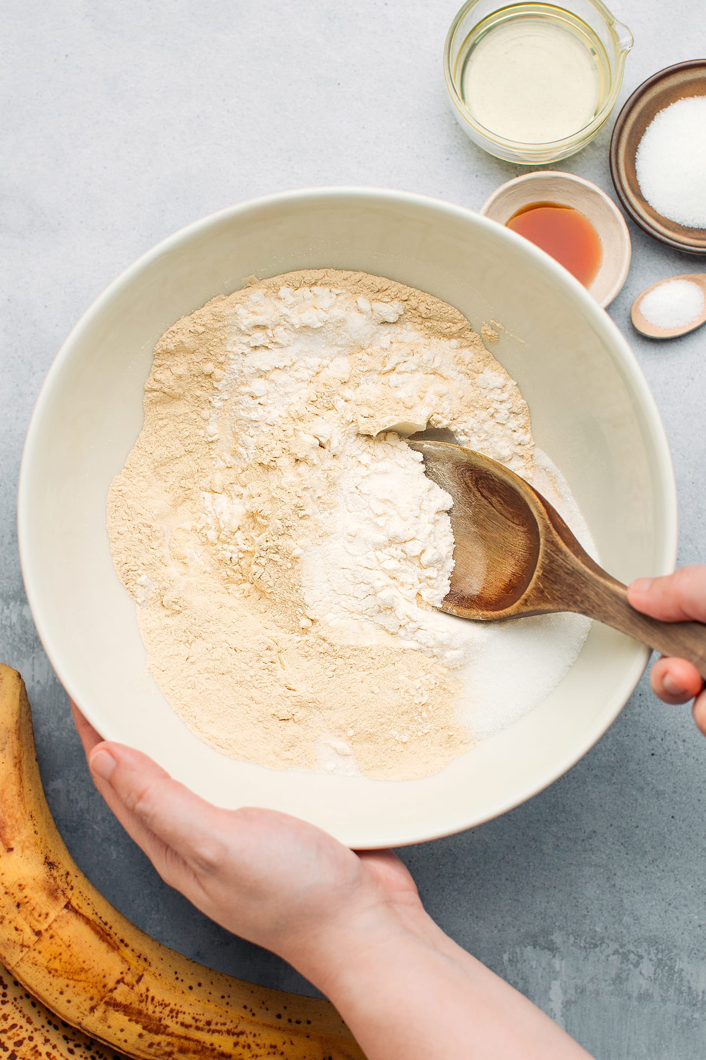 Whisking flour with protein powder and sugar.