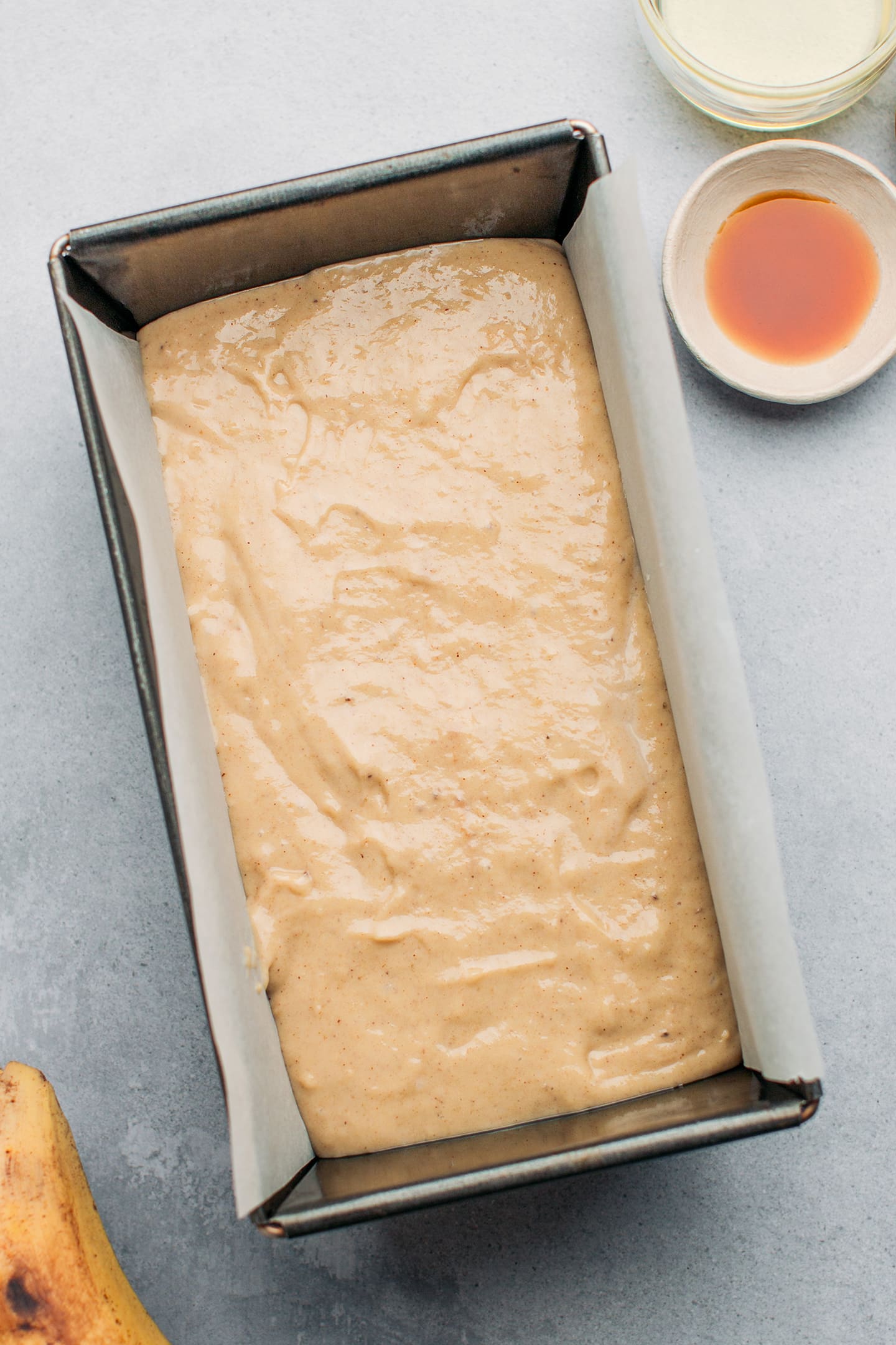 Banana bread batter in a loaf pan.