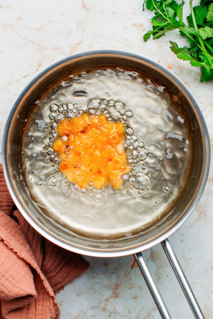 Corn fritter in a saucepan.