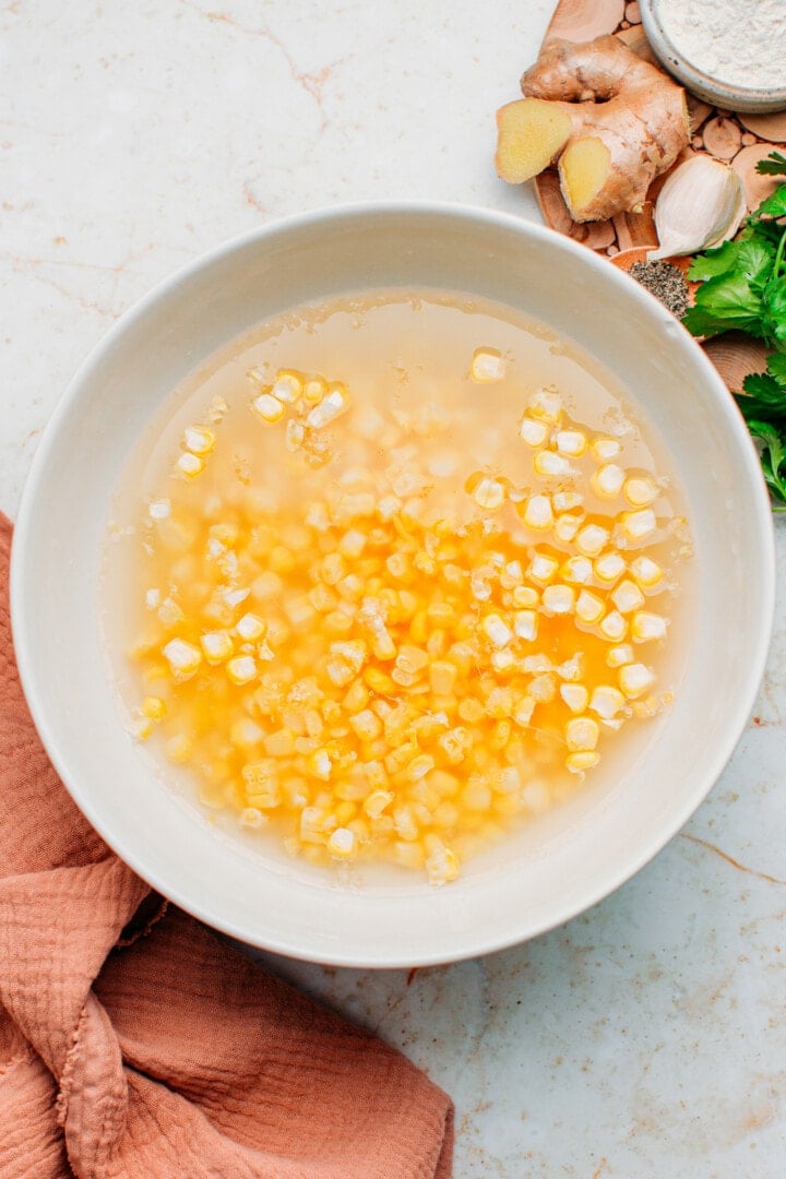 Corn kernels and water in a bowl.