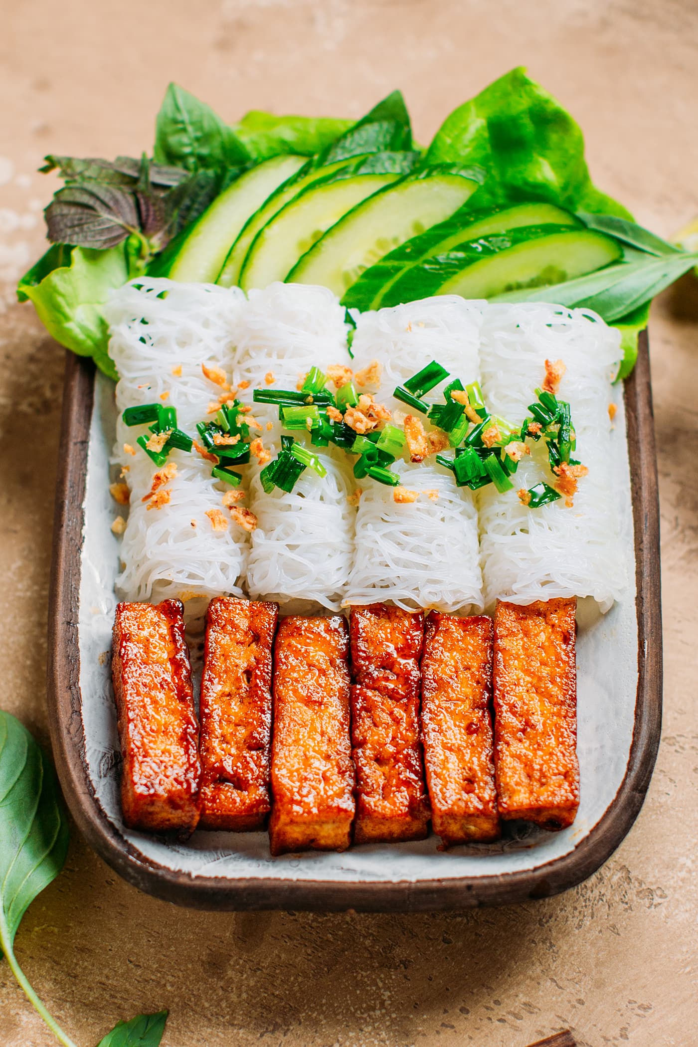 Vietnamese rice vermicelli woven with chewy tofu and fresh herbs.