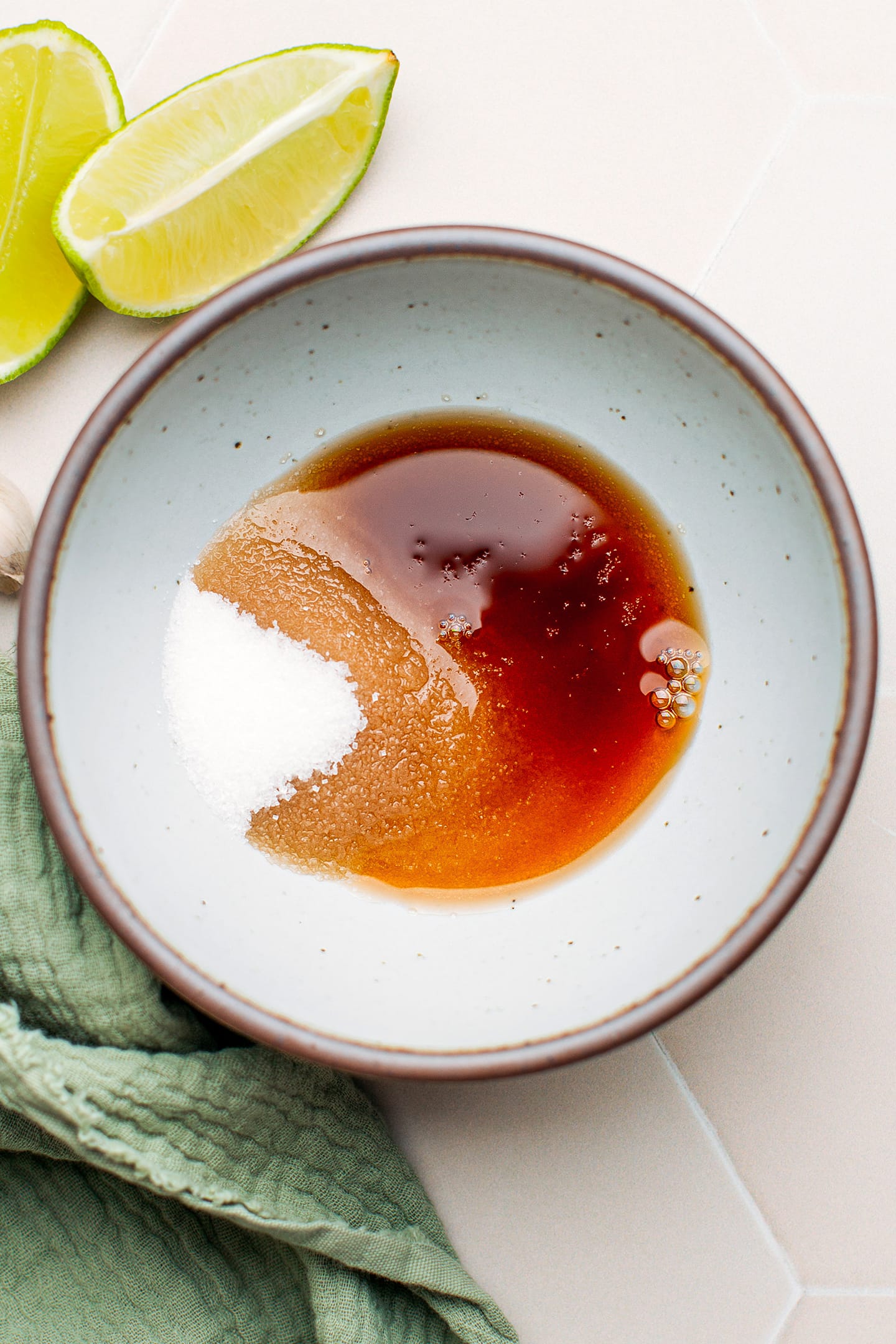 Sugar and fish sauce in a. bowl.