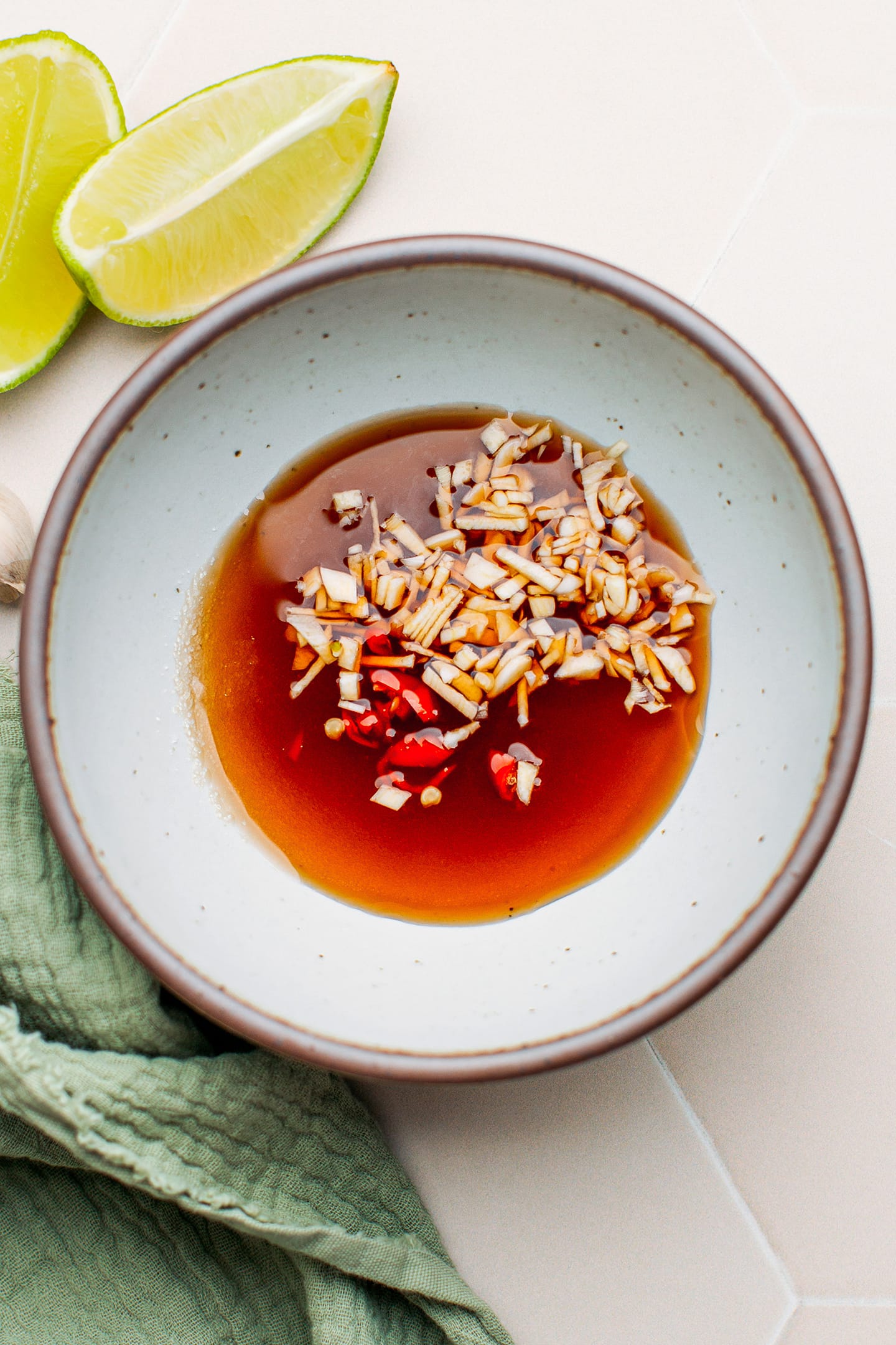 Sugar, fish sauce, garlic, and chili in a bowl.