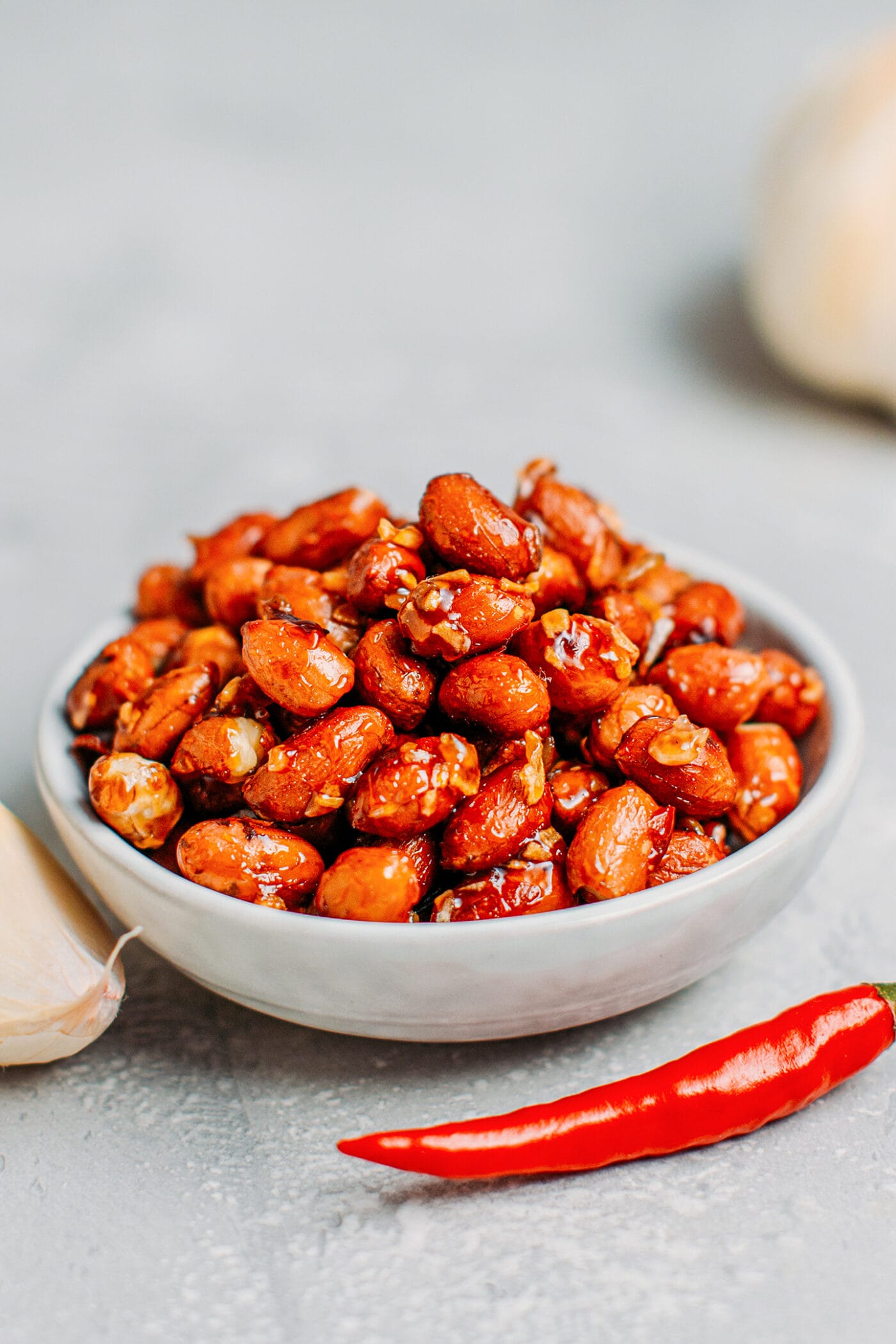 Glazed peanuts with garlic and chili in a bowl.