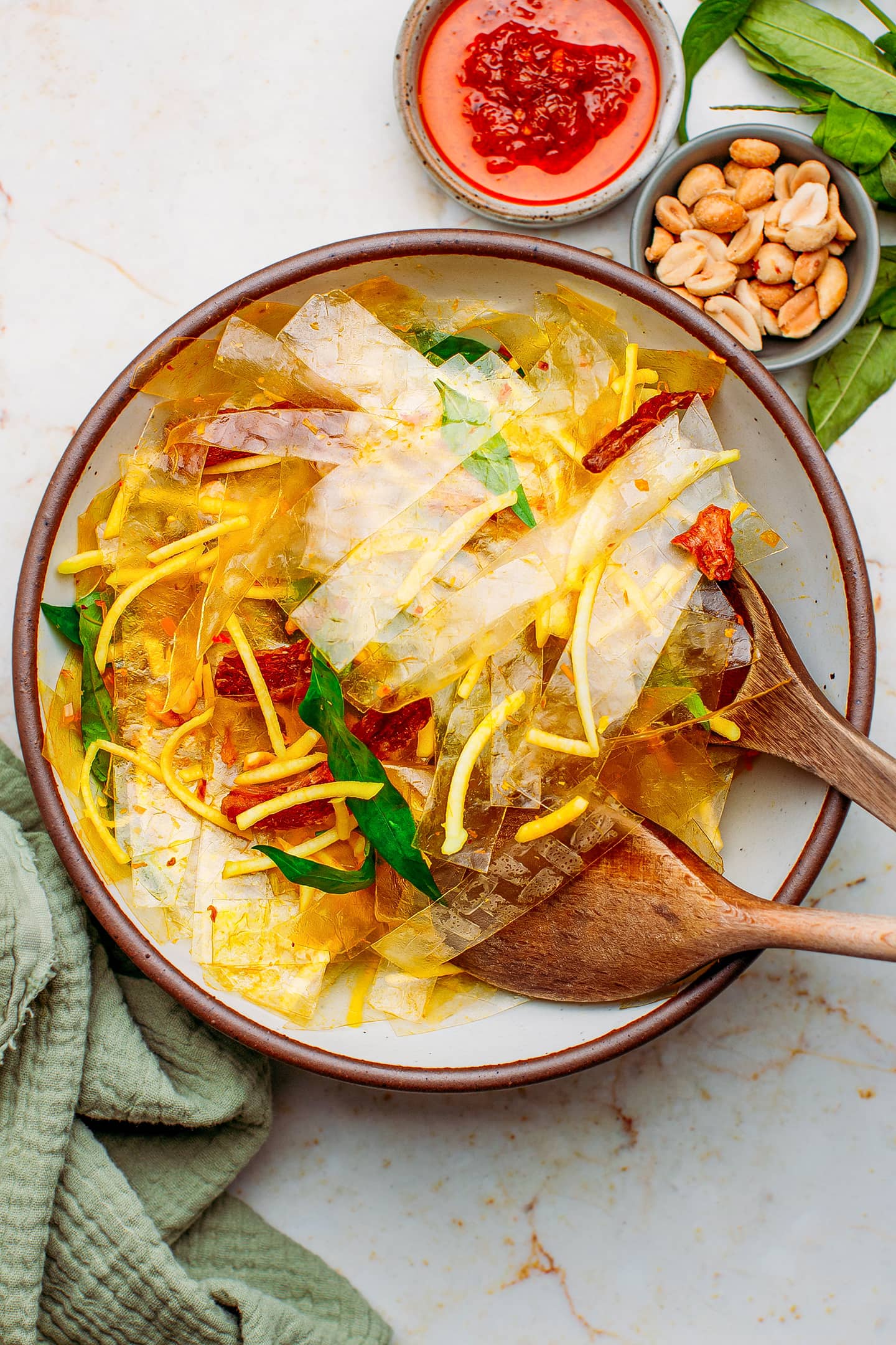 Rice paper, green mango, and Vietnamese coriander in a bowl.
